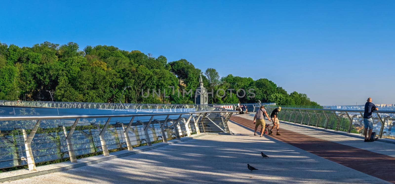 Kyiv, Ukraine 07.11.2020. Pedestrian glass bridge in Kyiv, Ukraine, on a sunny summer morning