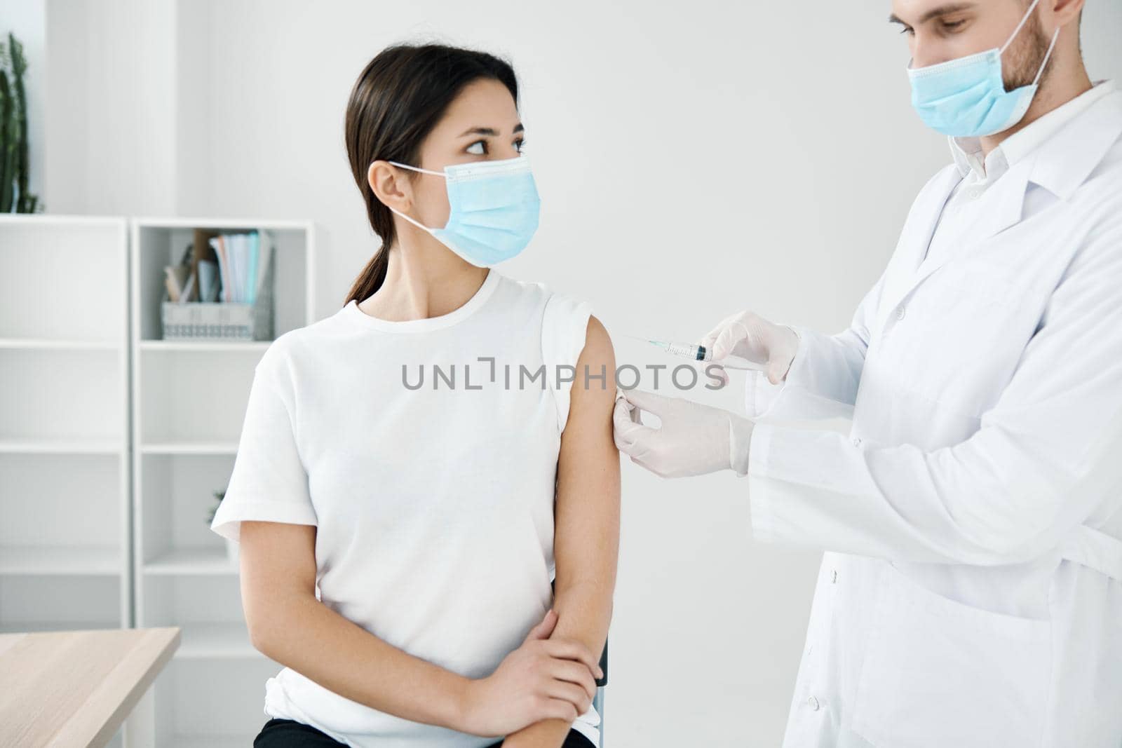 doctor in a medical smear injections to a woman patient from coronavirus by SHOTPRIME