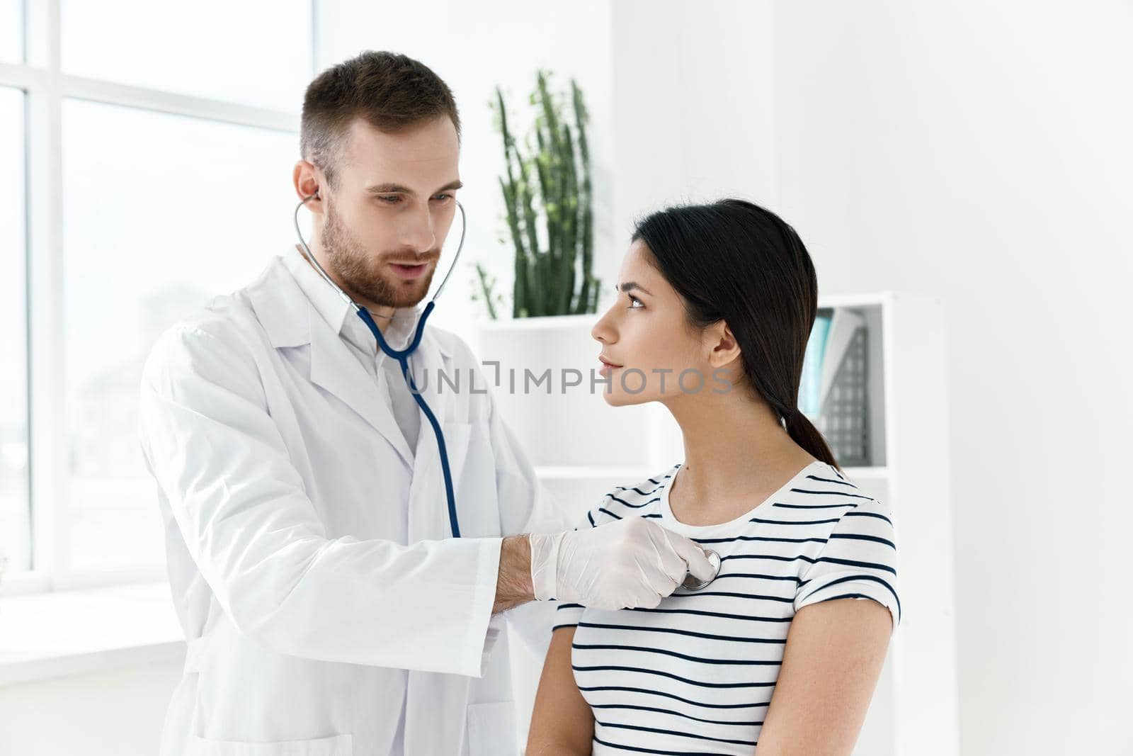 male doctor with a stethoscope examining a patient. High quality photo