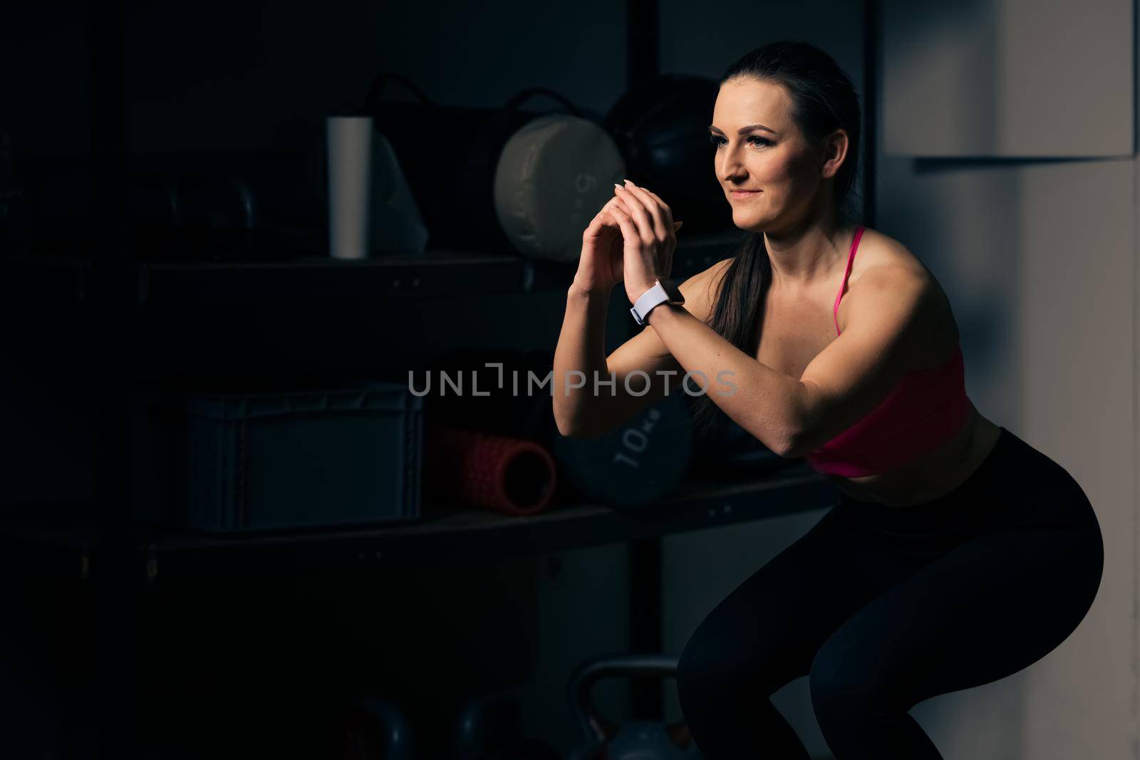 squat on a balance pad during fitness exercises by Edophoto