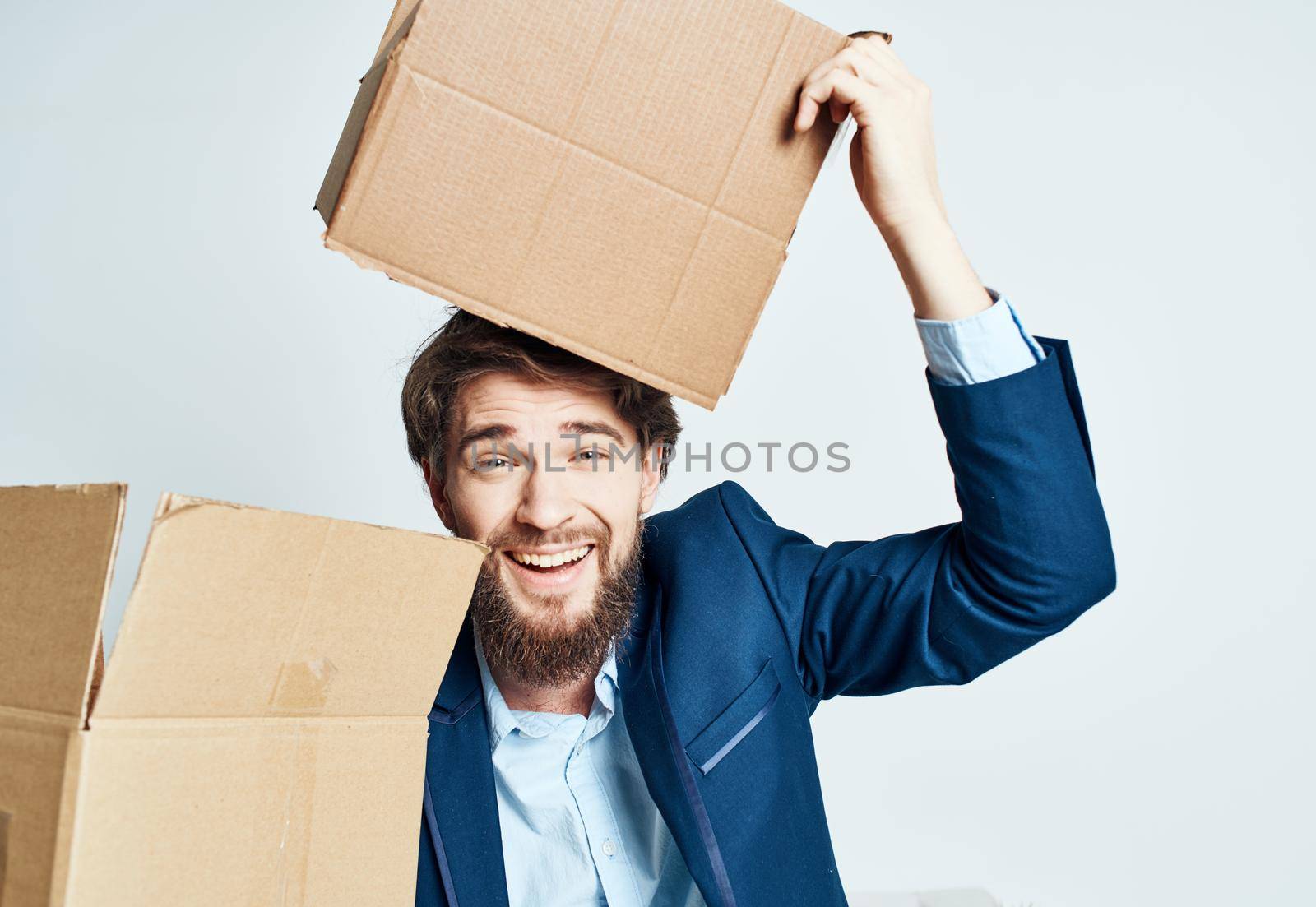 A man with boxes while a suit is moving unpacking. High quality photo