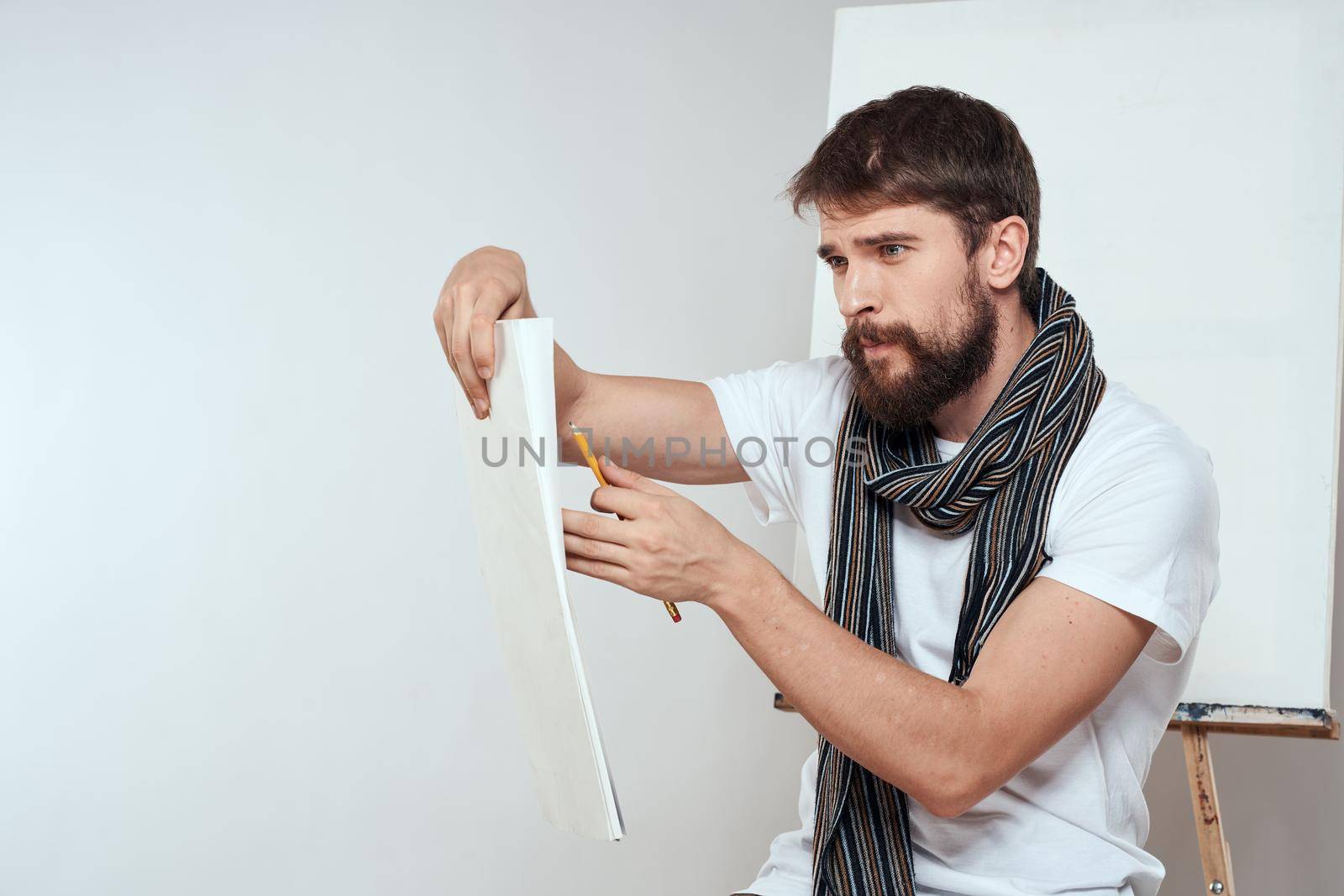Man in white t-shirt artist drawing creativity work. High quality photo