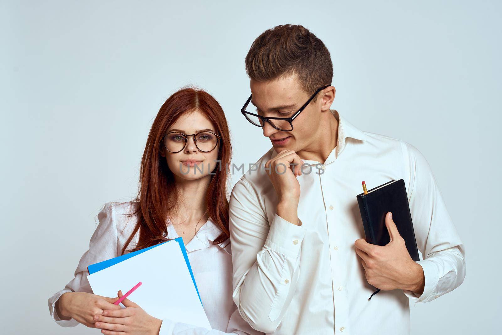 Young couple in white shirts are communication professional officials. High quality photo