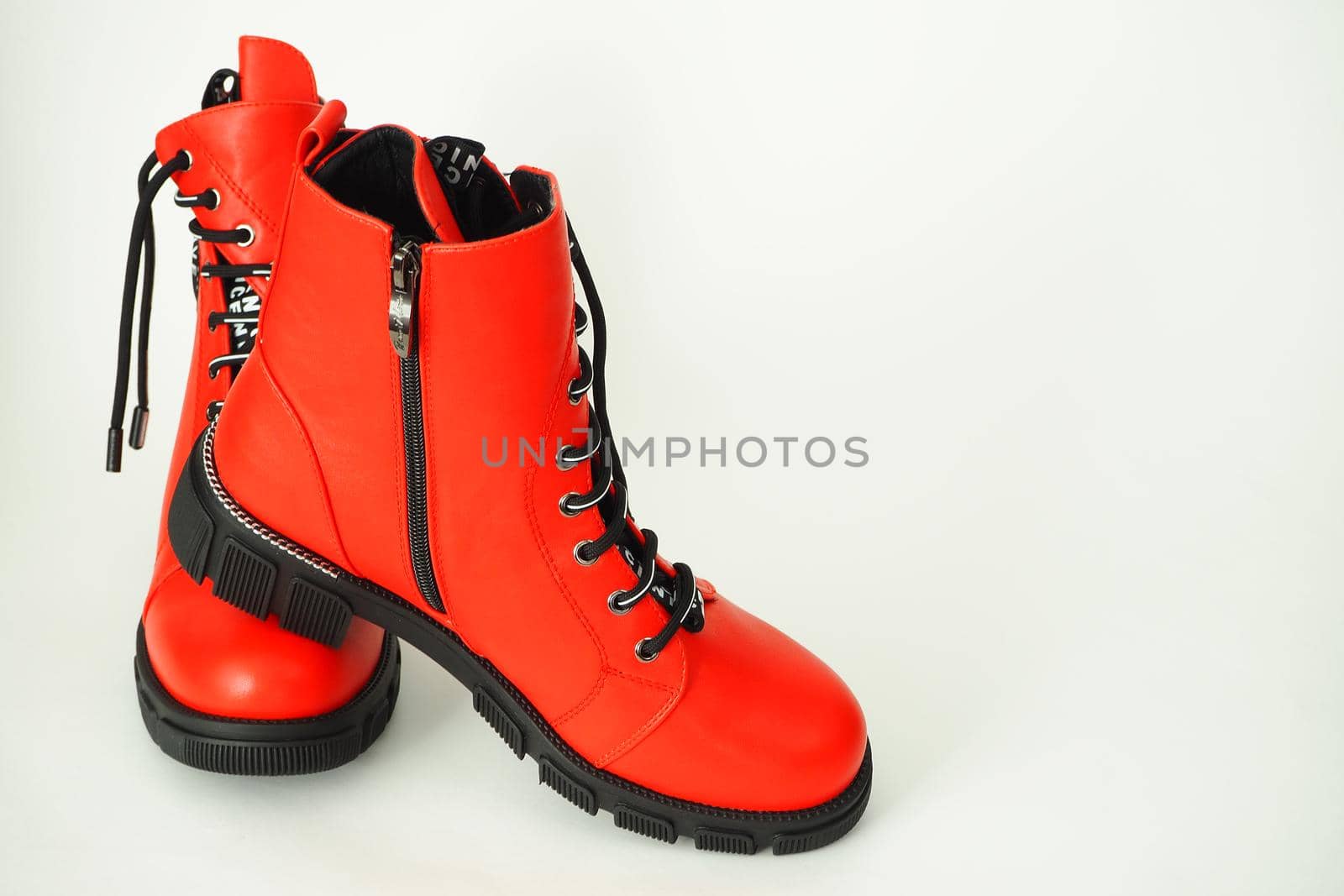 Fashionable women's shoes are red, with zipper and lacing, insulated on a white background. High quality photo
