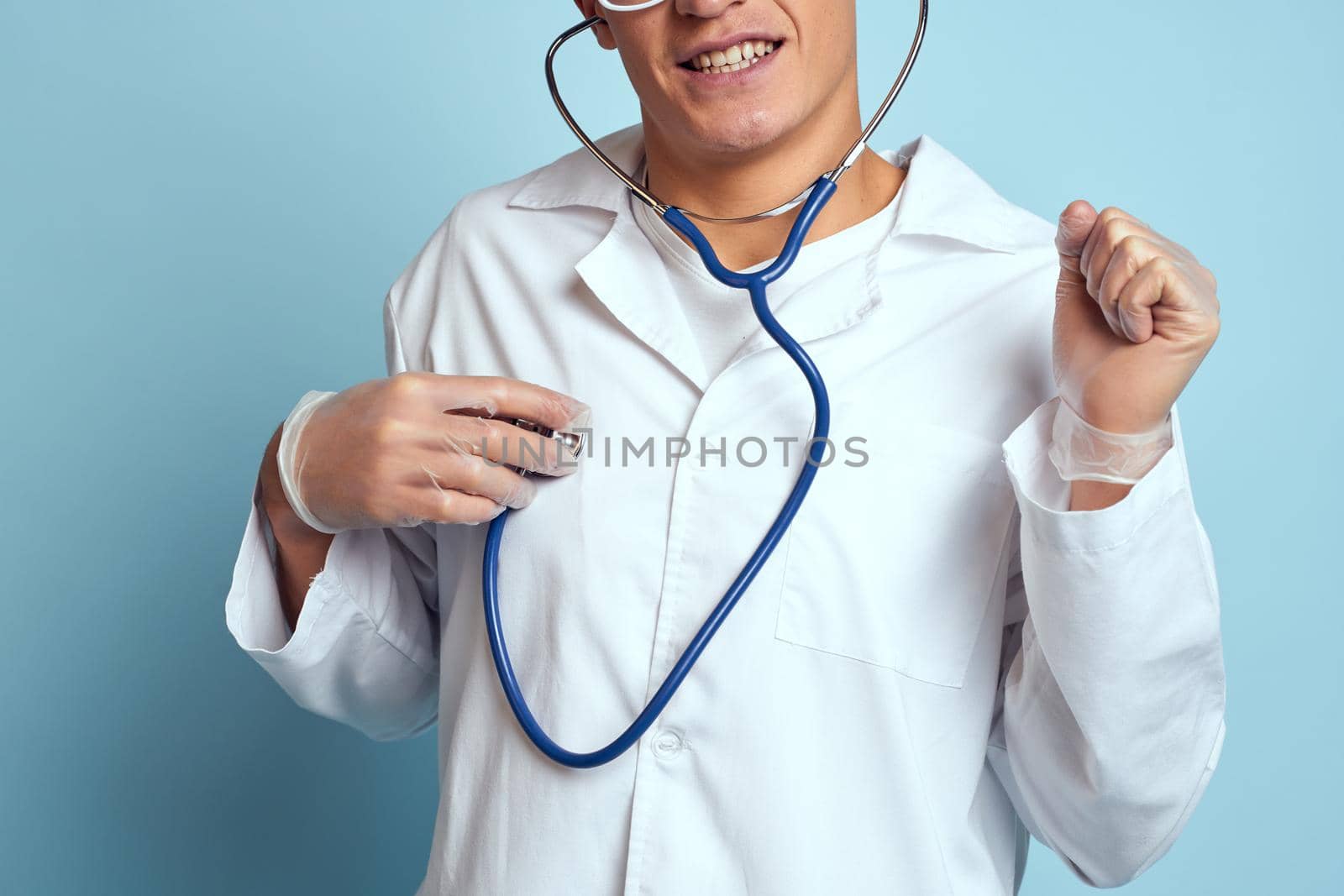 Male doctor white coat treatment medical instruments blue background. High quality photo