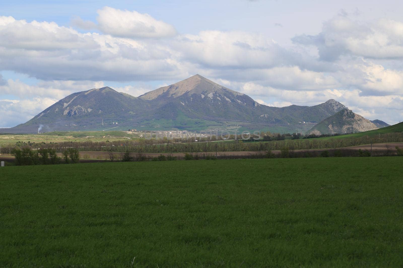 Beautiful natural landscape with green vegetation and mountains in the background.