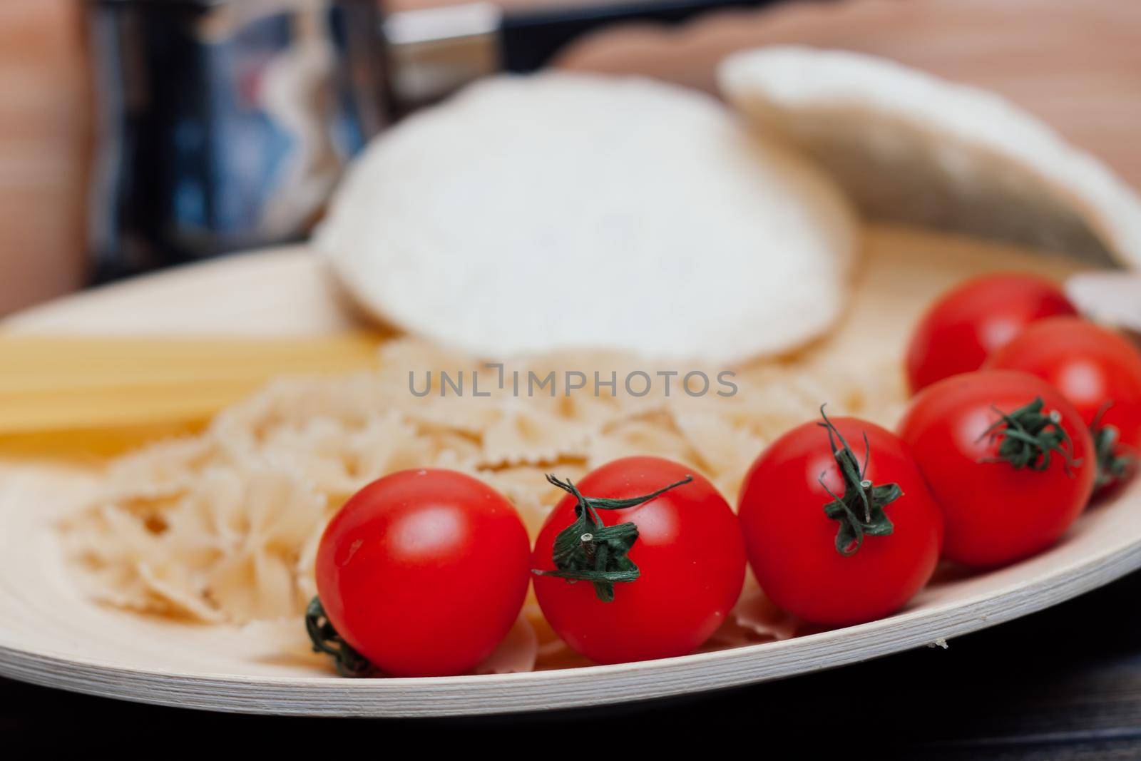 ingredients for making italian pasta cherry tomatoes sauce kitchen. High quality photo