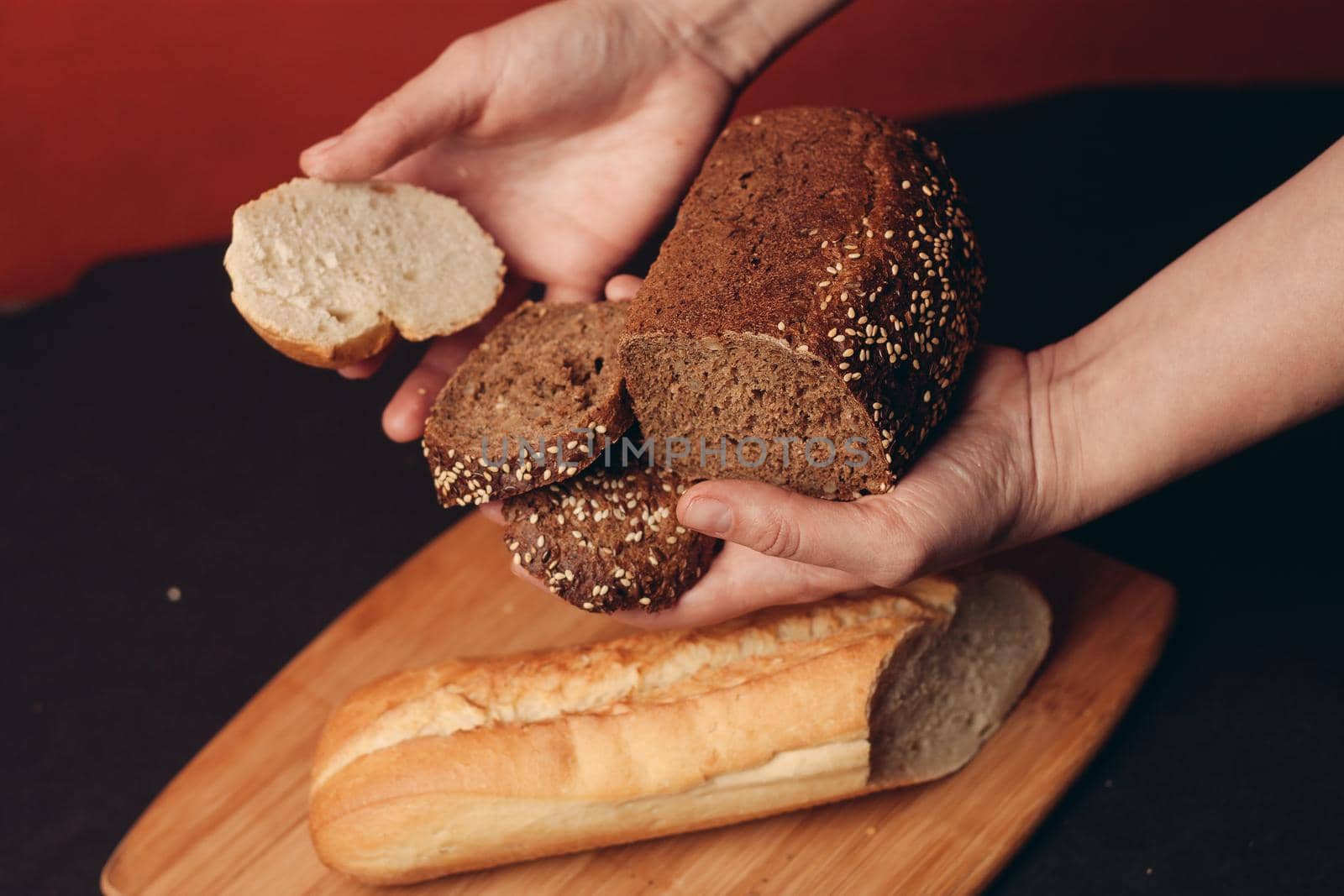 sliced white baguette and a loaf of rye bread on a board. High quality photo