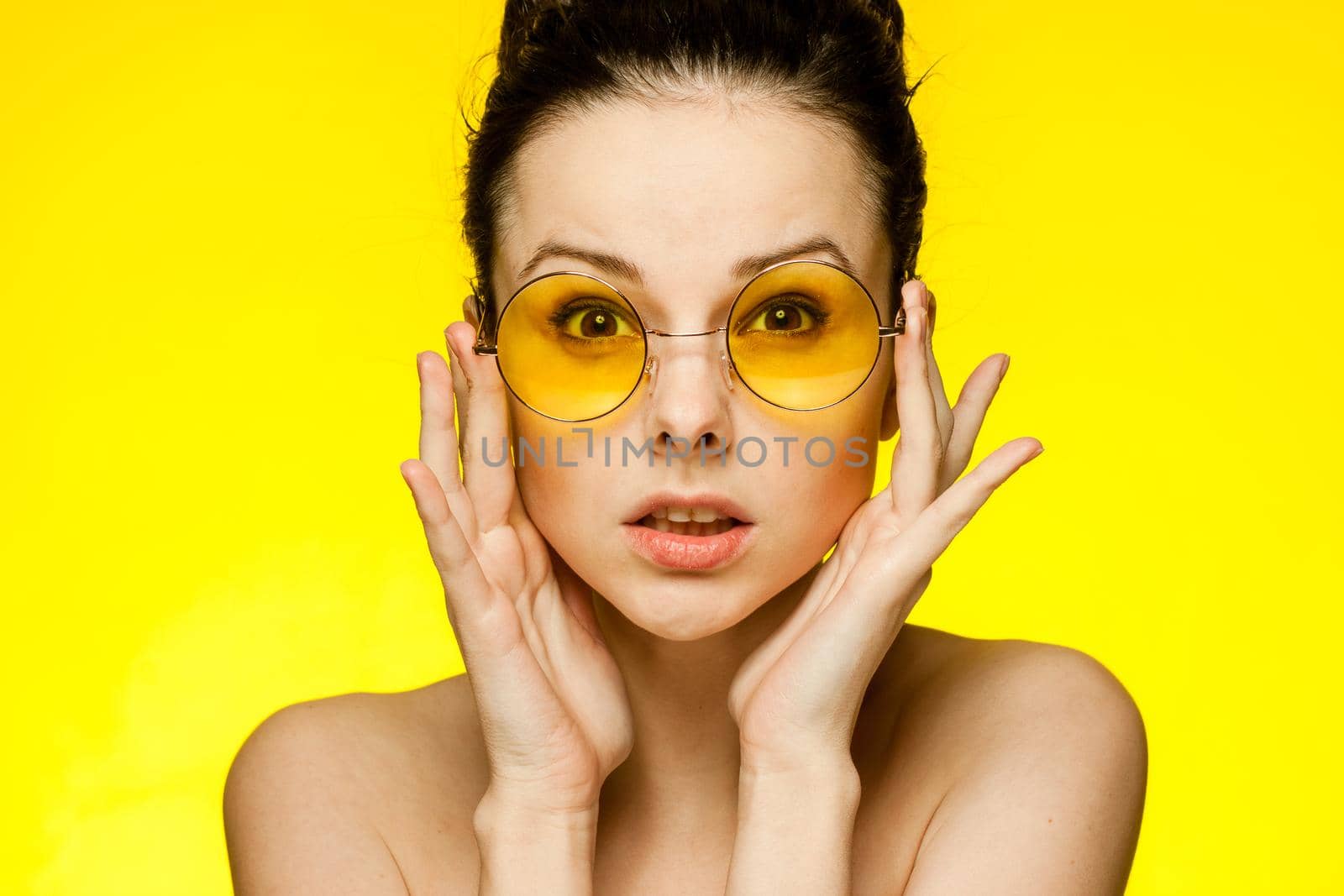 woman with bare shoulders wearing glasses gathered hair smile by SHOTPRIME