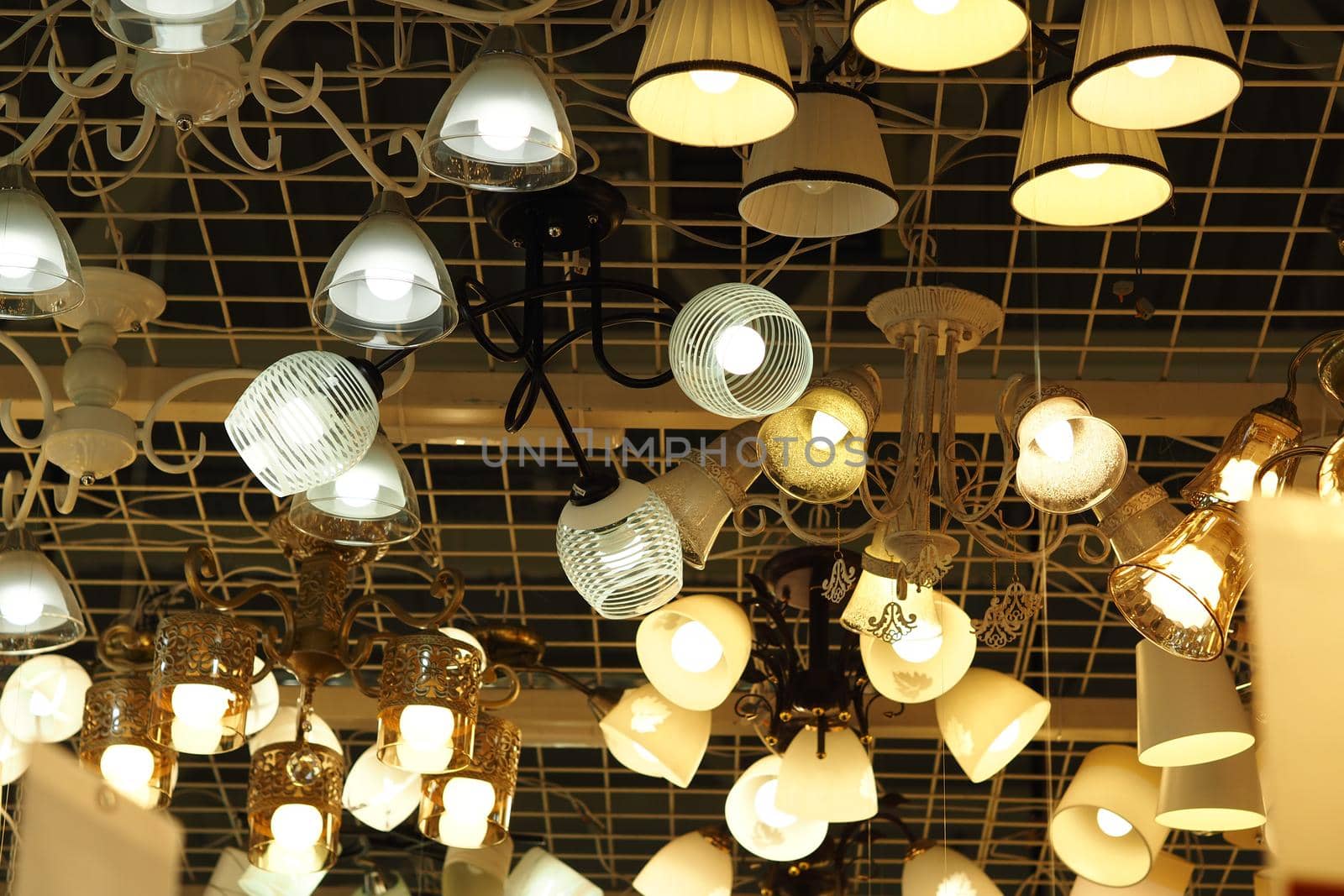 Sales, chandeliers, lamps and table lamps in the store. High quality photo