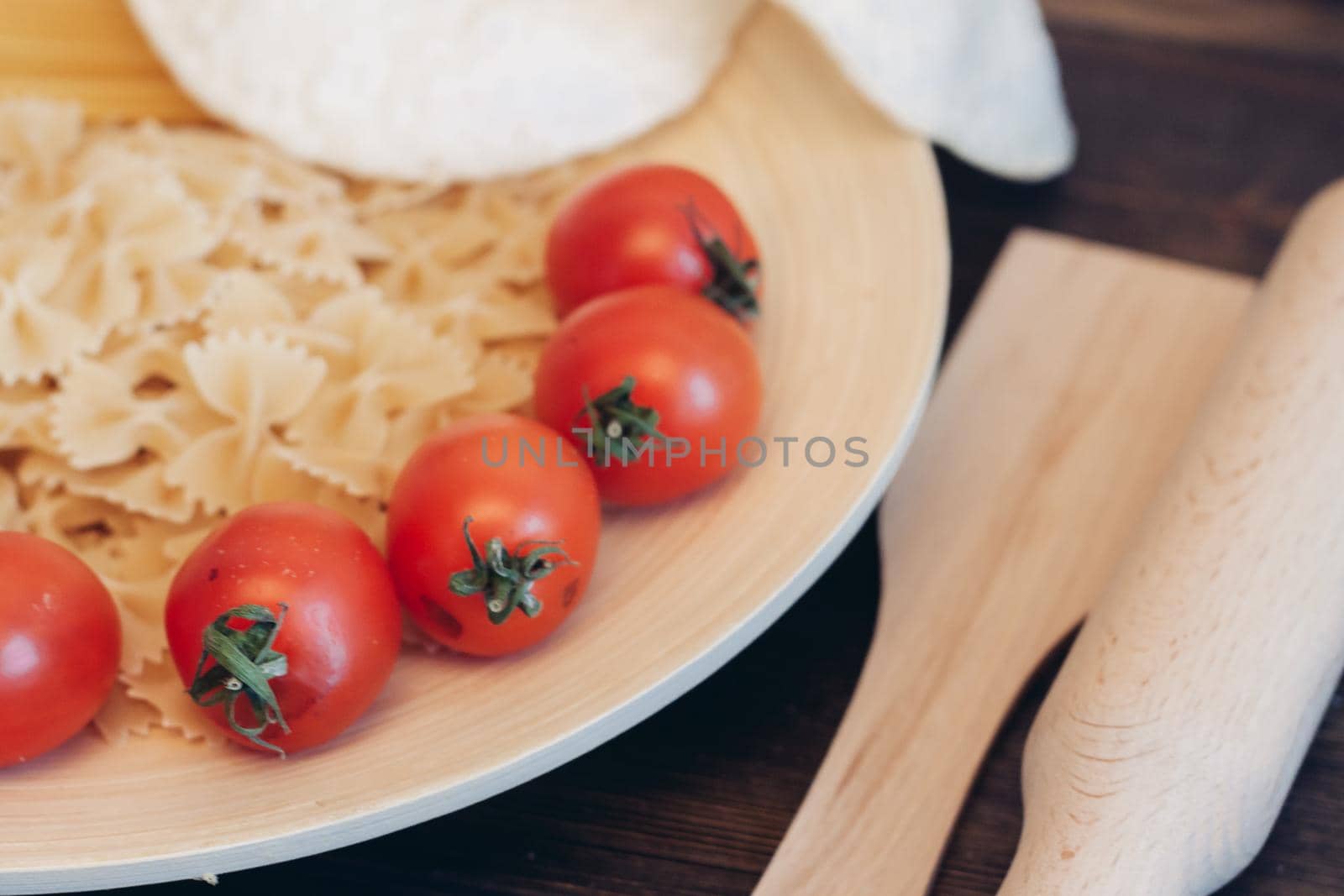 italian pasta on a wooden table cherry tomatoes cooking. High quality photo