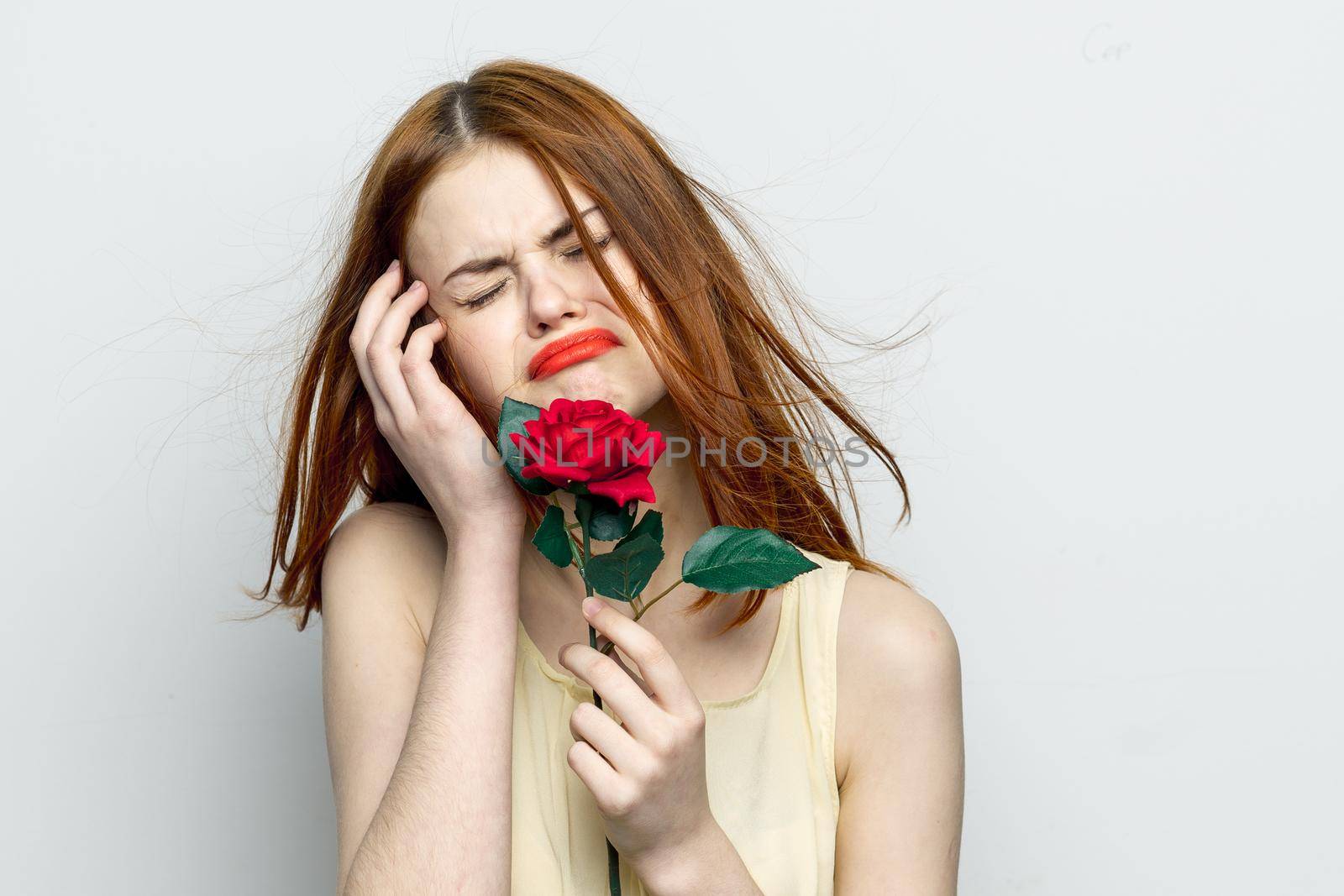 emotional woman with rose flower displeasure cry . High quality photo