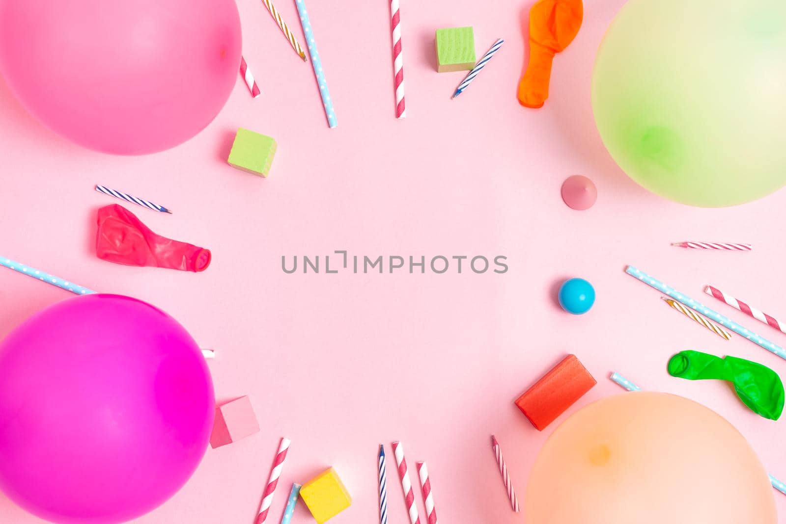 Colorful balloons and confetti on blue table top view. Festive or party background. Flat lay style. Copy space for text. Birthday greeting card.