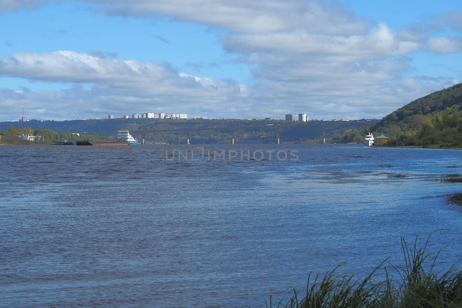 A large river view from the shore. Clean water. It's a beautiful panorama.