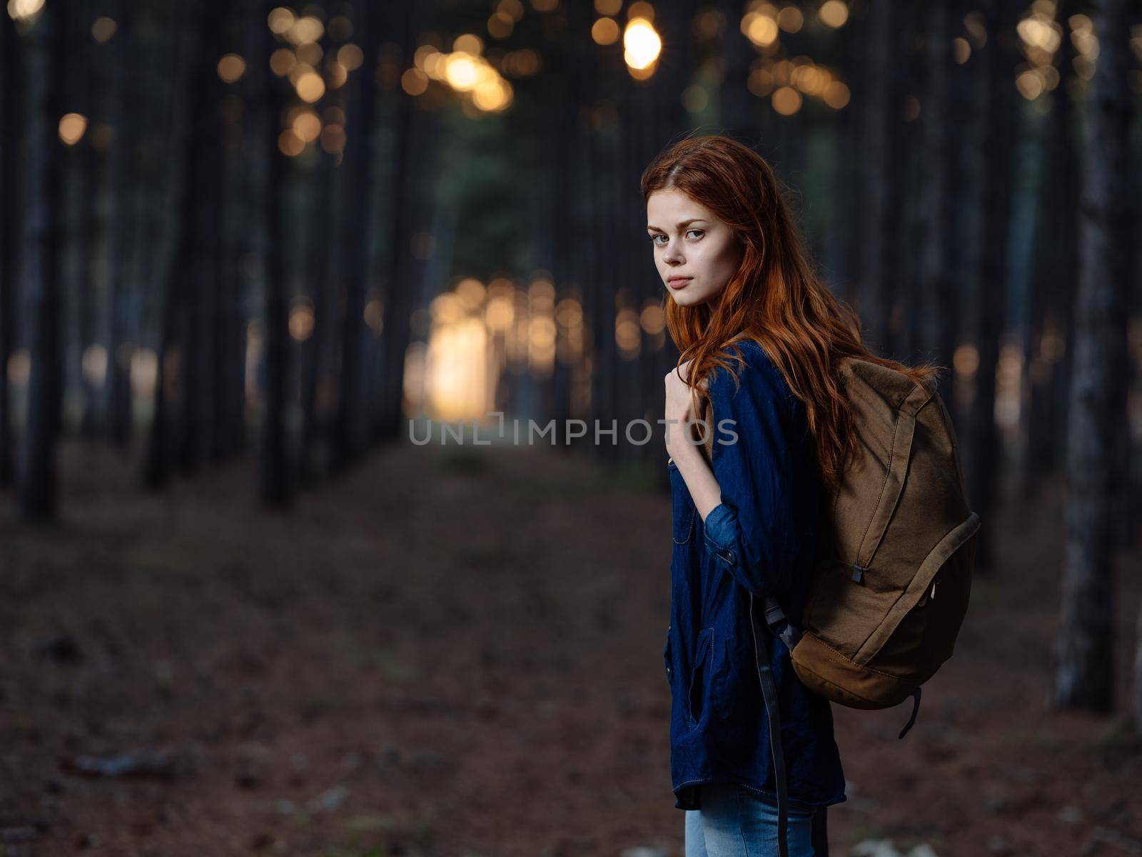 Happy woman travels among pine trees in nature in the forest by SHOTPRIME