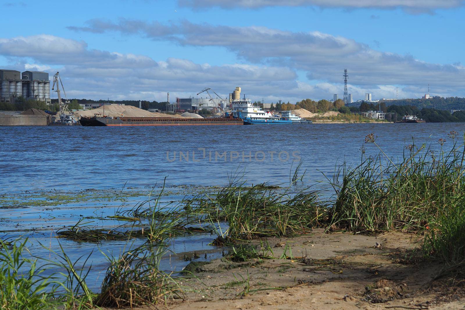 River sand mining. A wide river, a view from the shore.