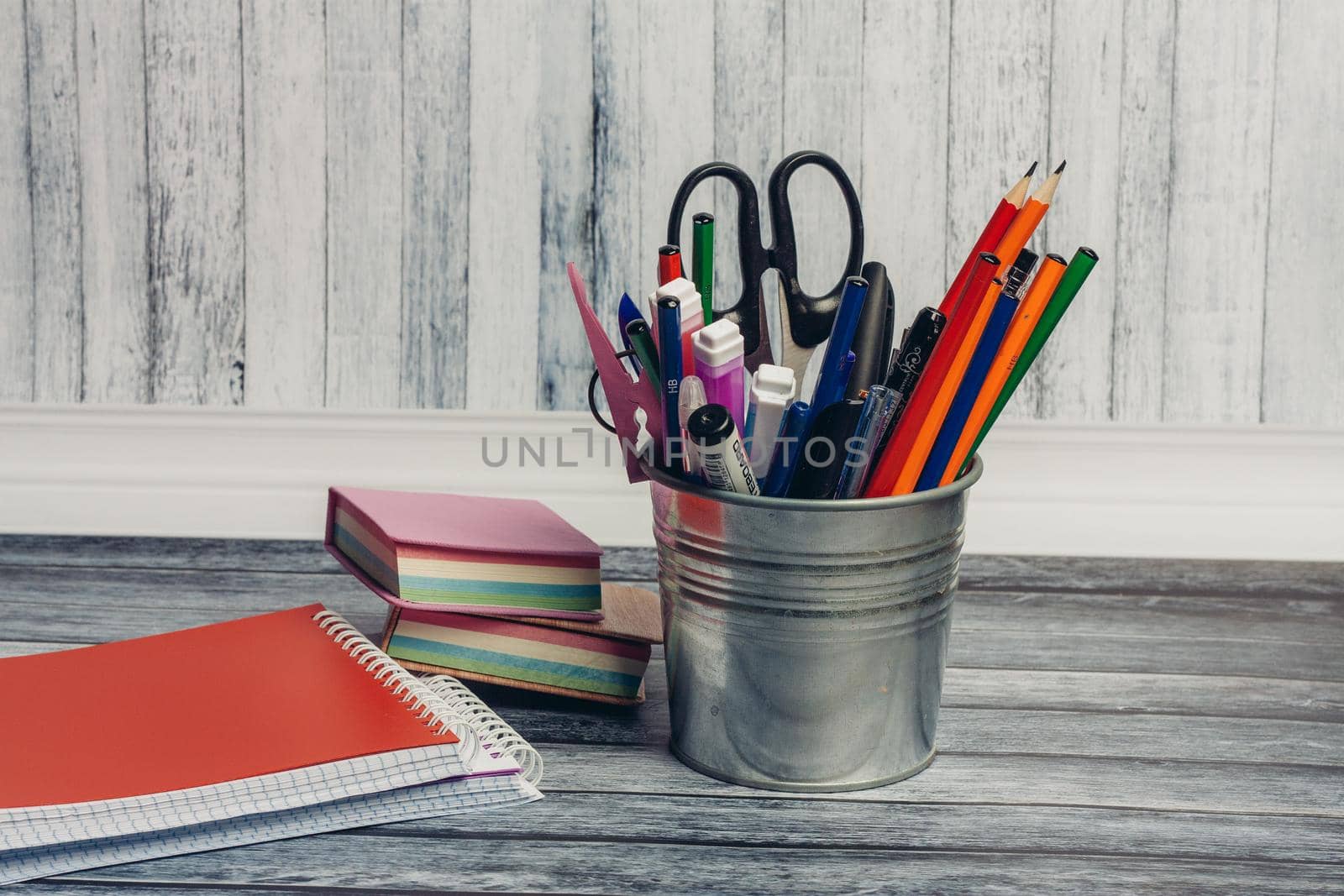 red notepad and stationery stand scissors colored pencils school markers. High quality photo