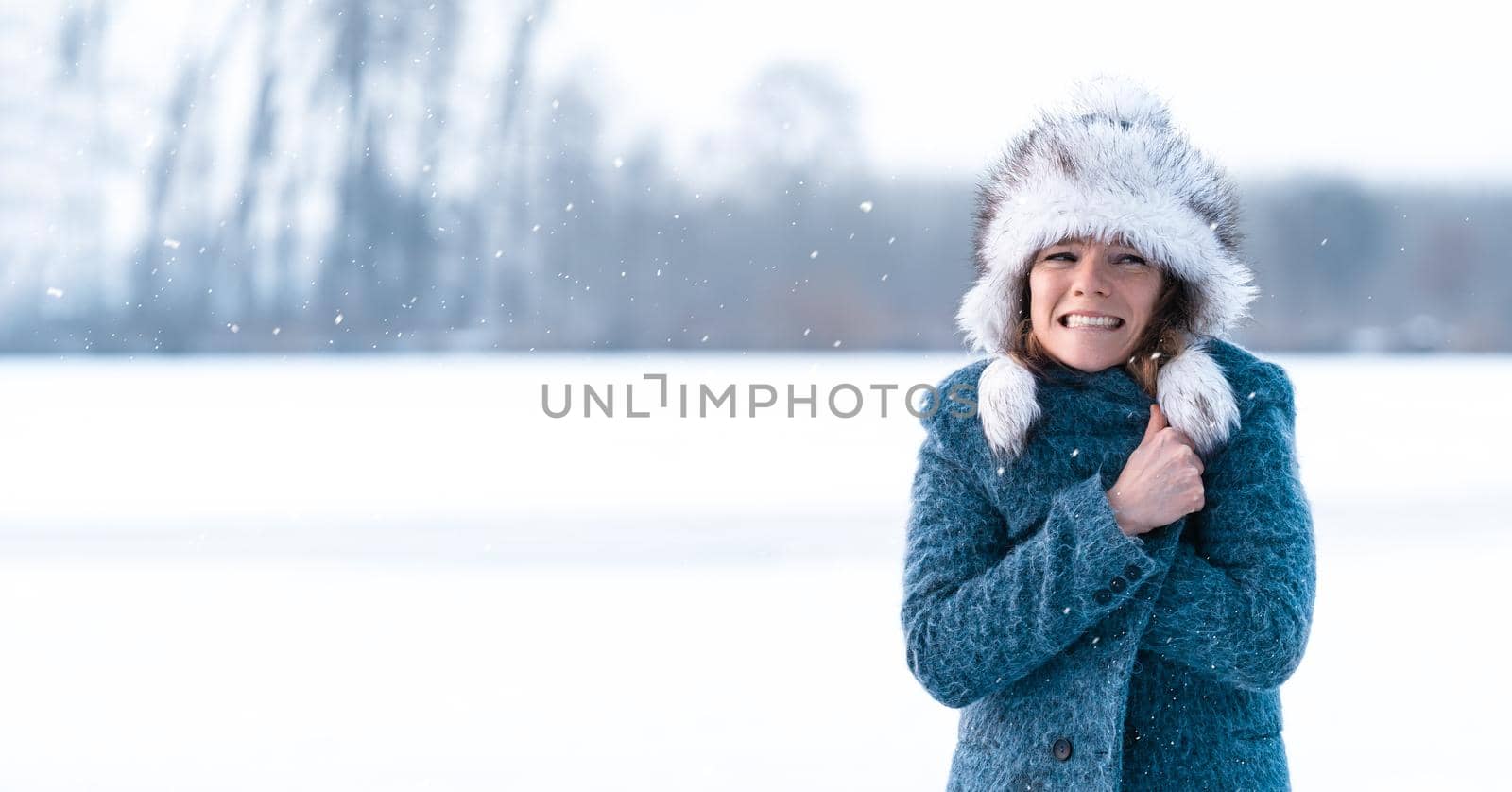 freezing woman on winter icy lake.
