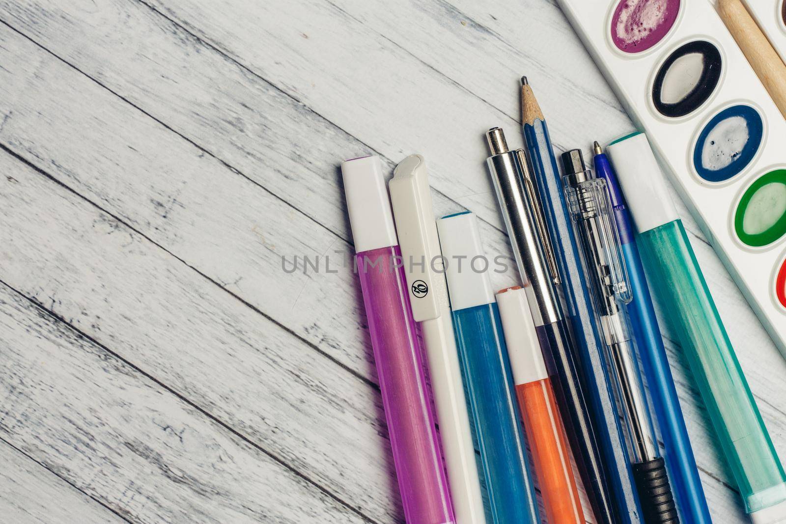 paint colored pencils handles wooden background texture. High quality photo