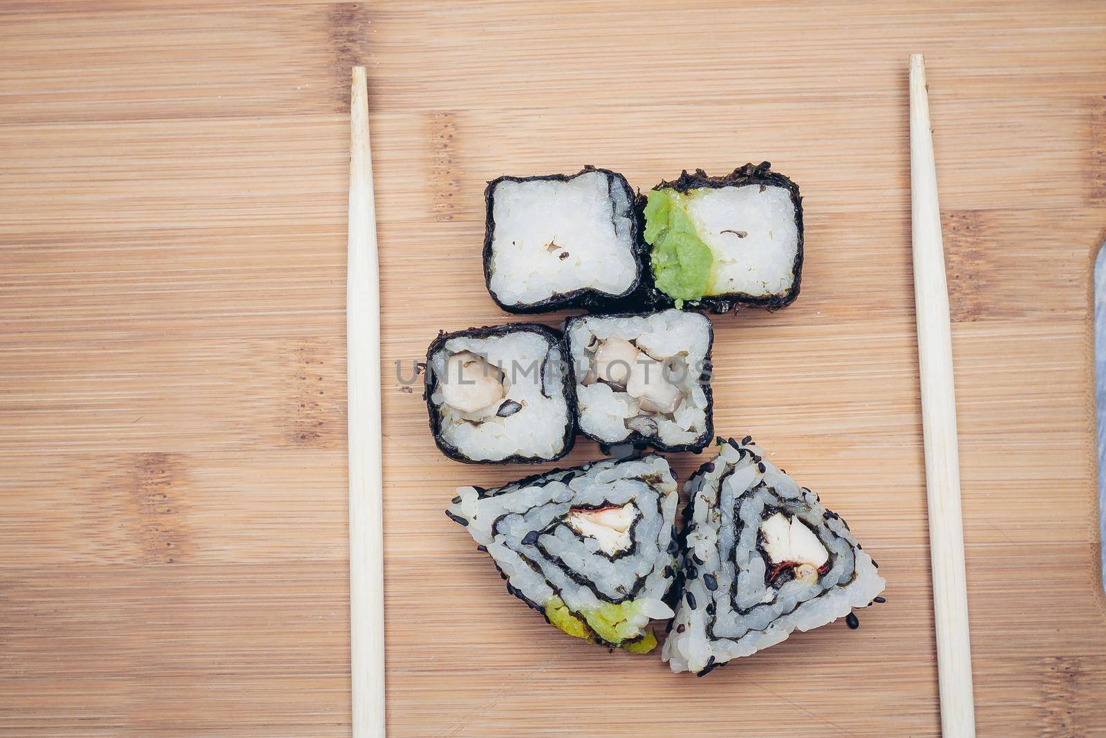 triangular sushi rolls chopsticks wood board japanese cuisine. High quality photo
