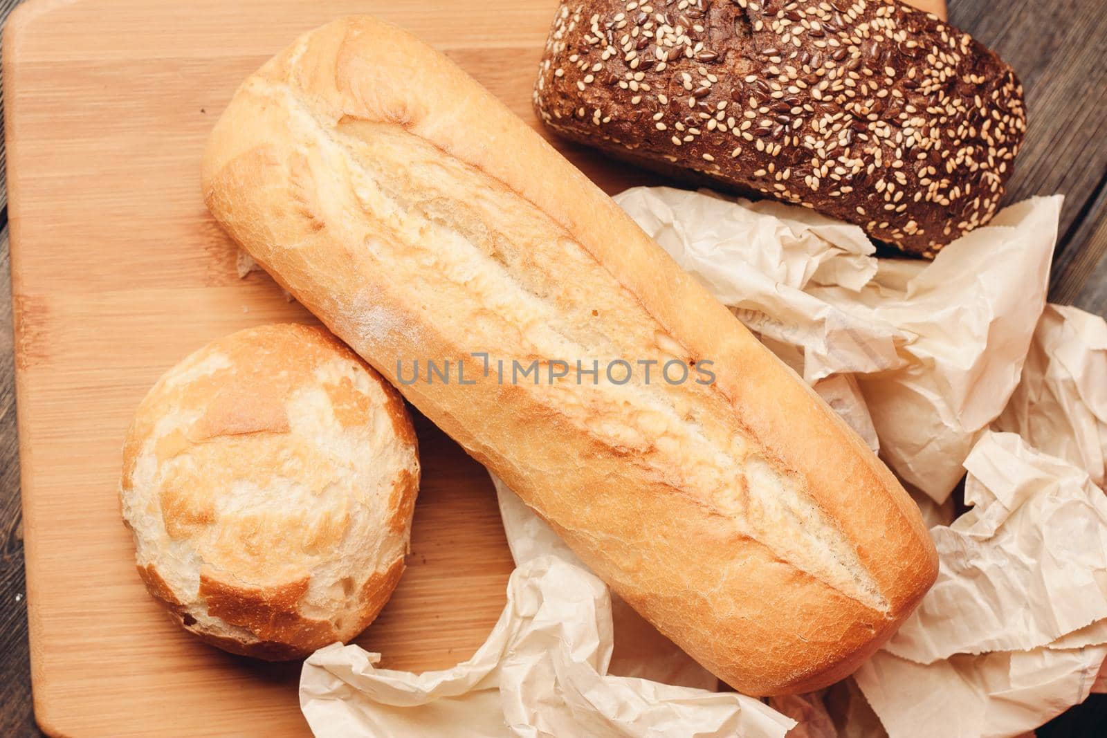 flour products loaf of bread and wood board light background. High quality photo