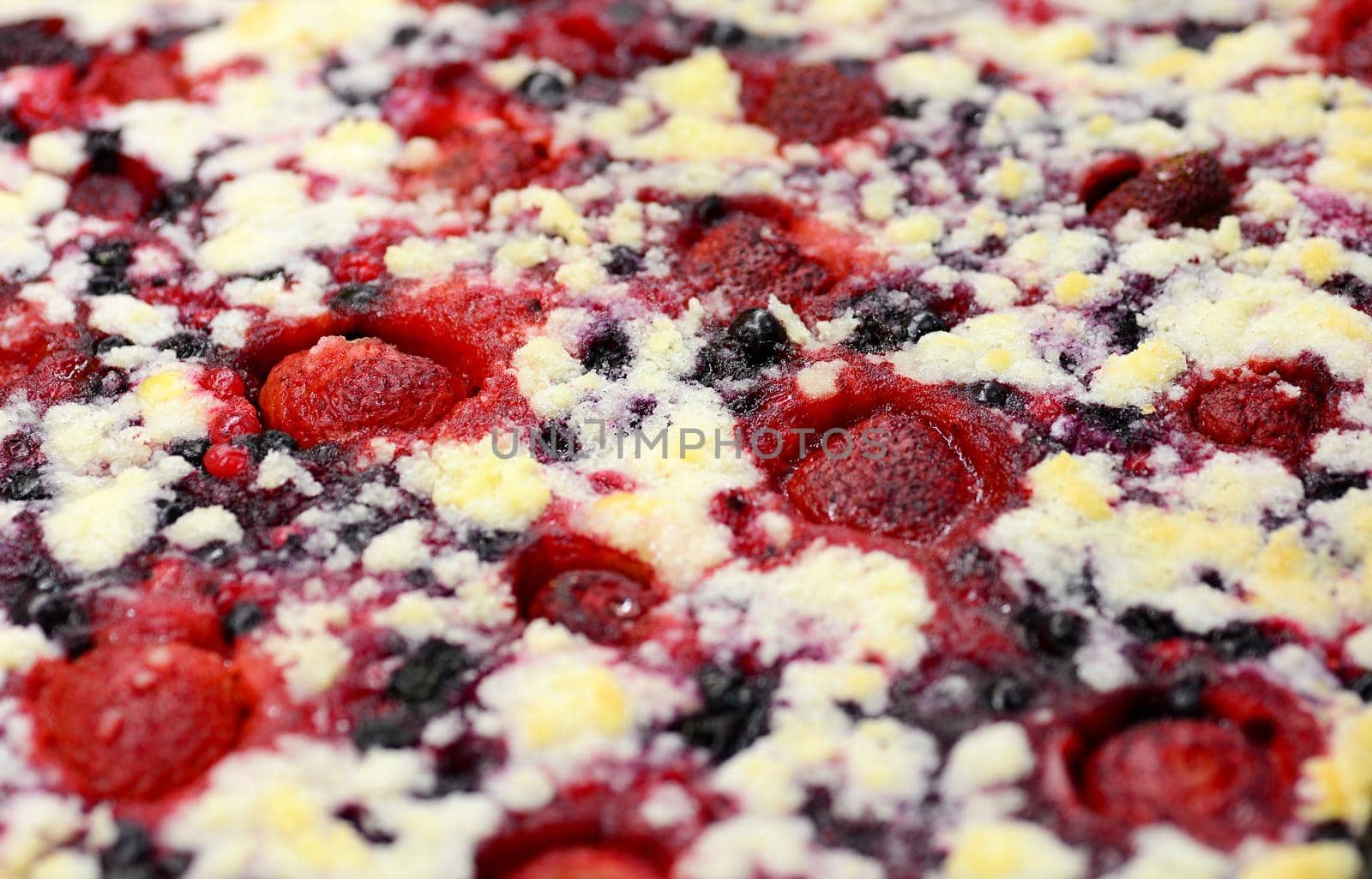 Full frame background of freshly baked cake with berries and strawberries fruit.