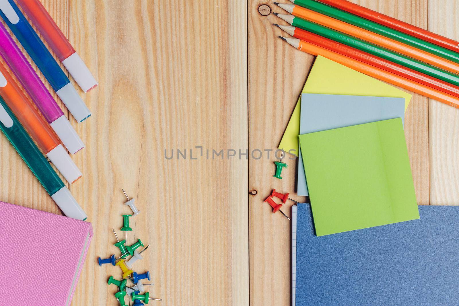 multicolored markers pencils stickers stationery close-up top view. High quality photo
