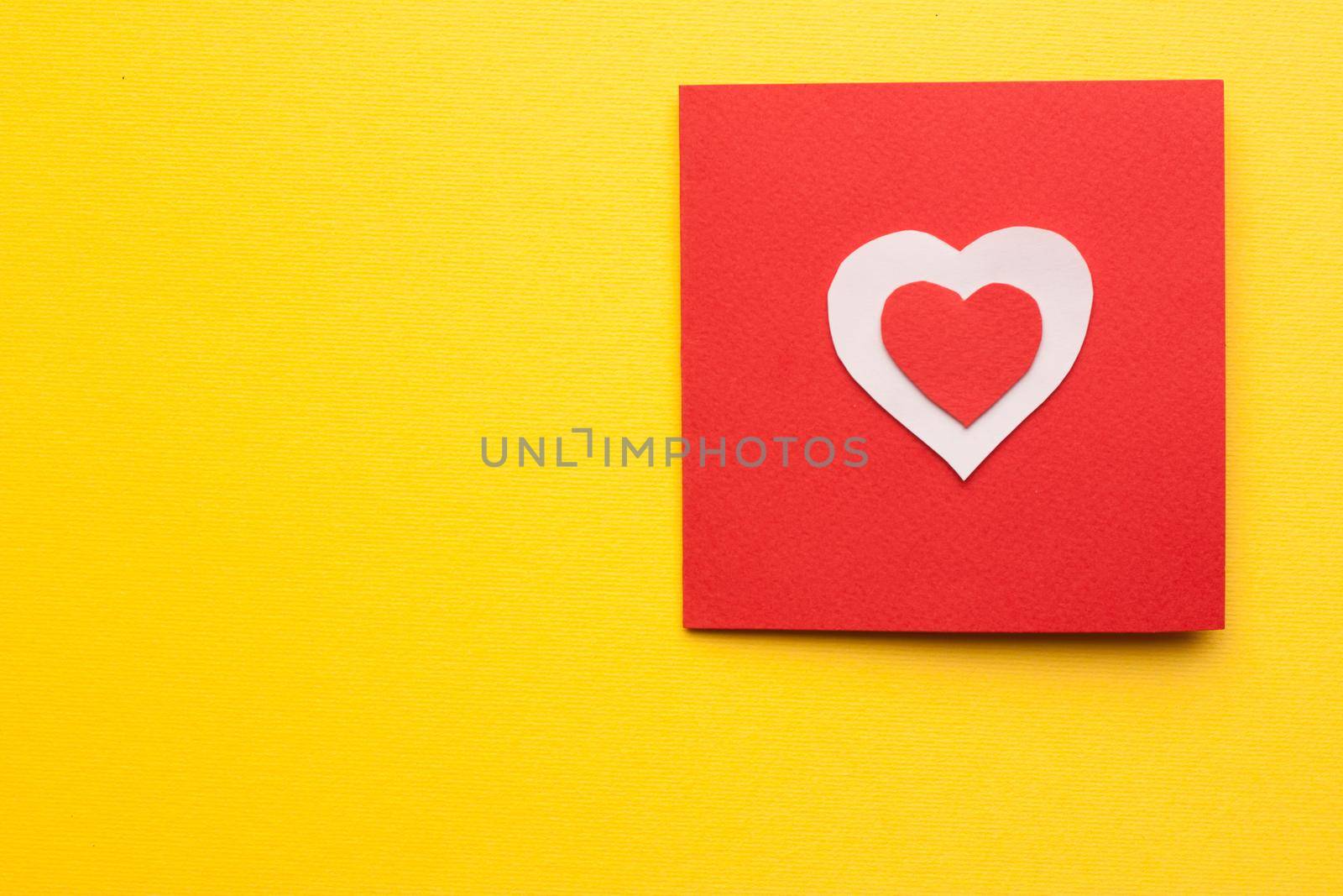 card with heart valentine holiday decoration yellow background. High quality photo