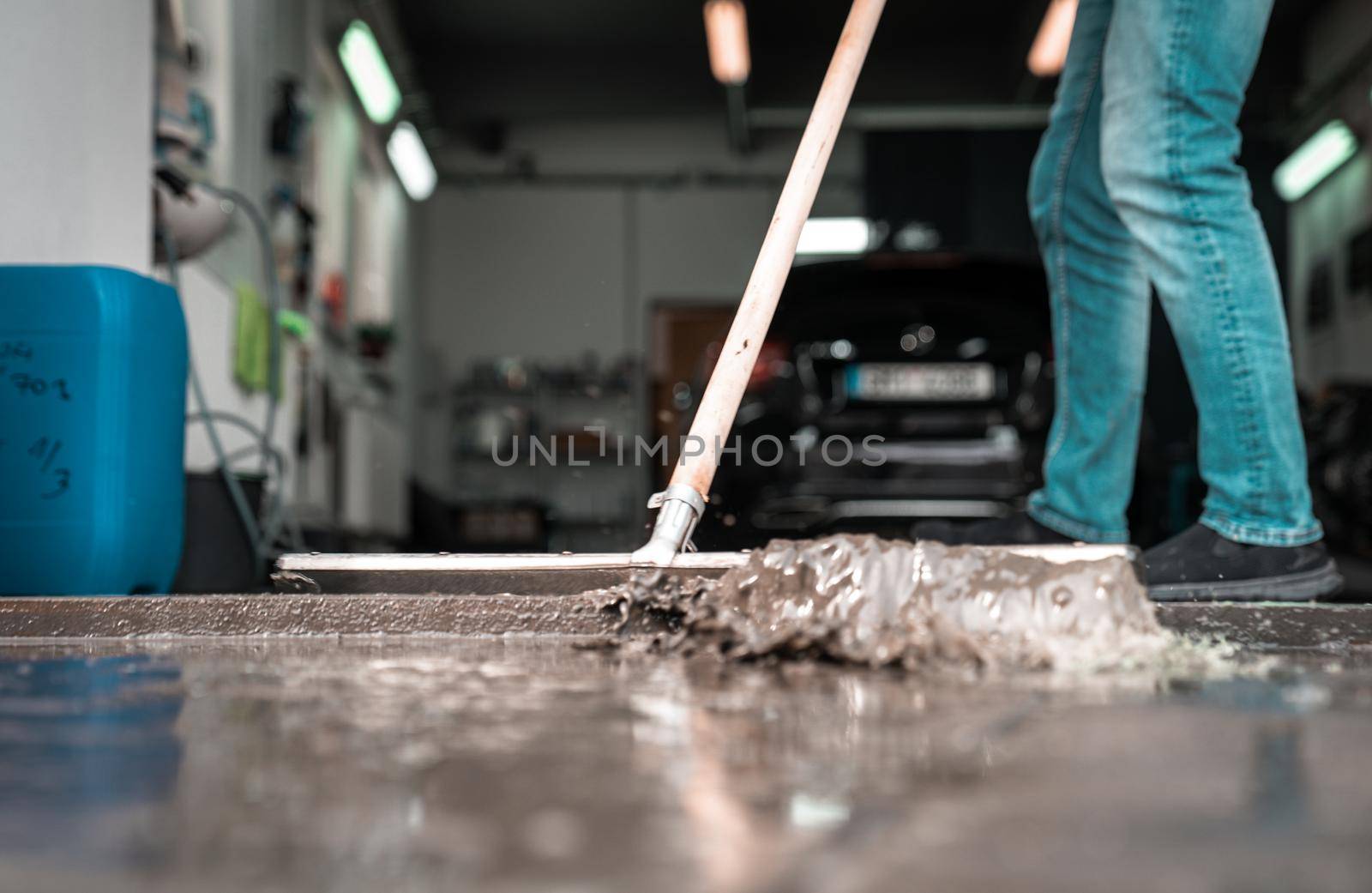 Clean the floor at the car wash with the help of a water spatula by Edophoto