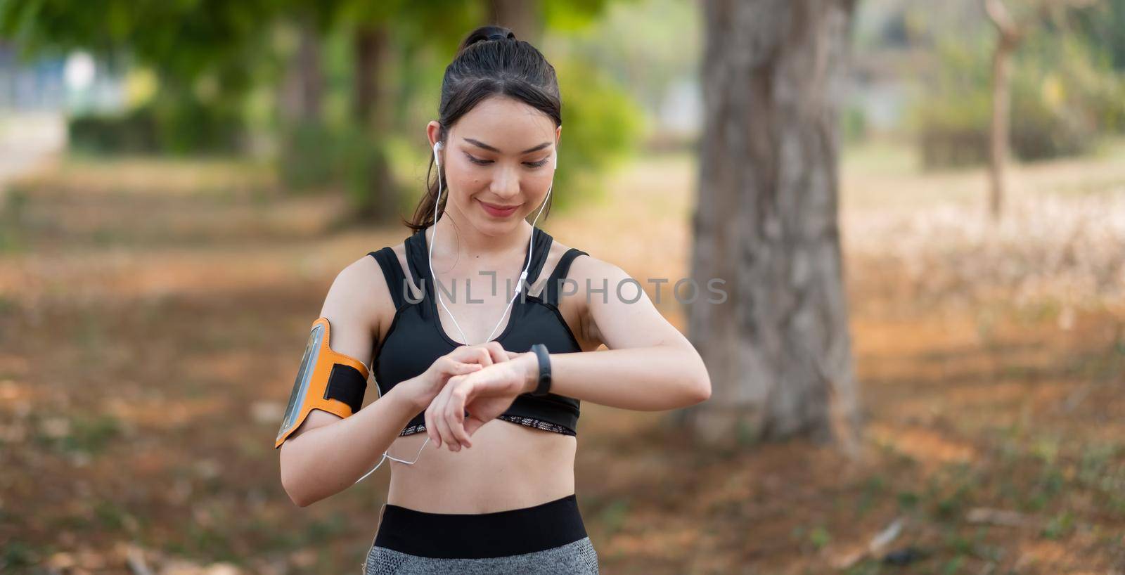 Young woman workout at outdoor using smart watch healthy lifestyle. by nateemee