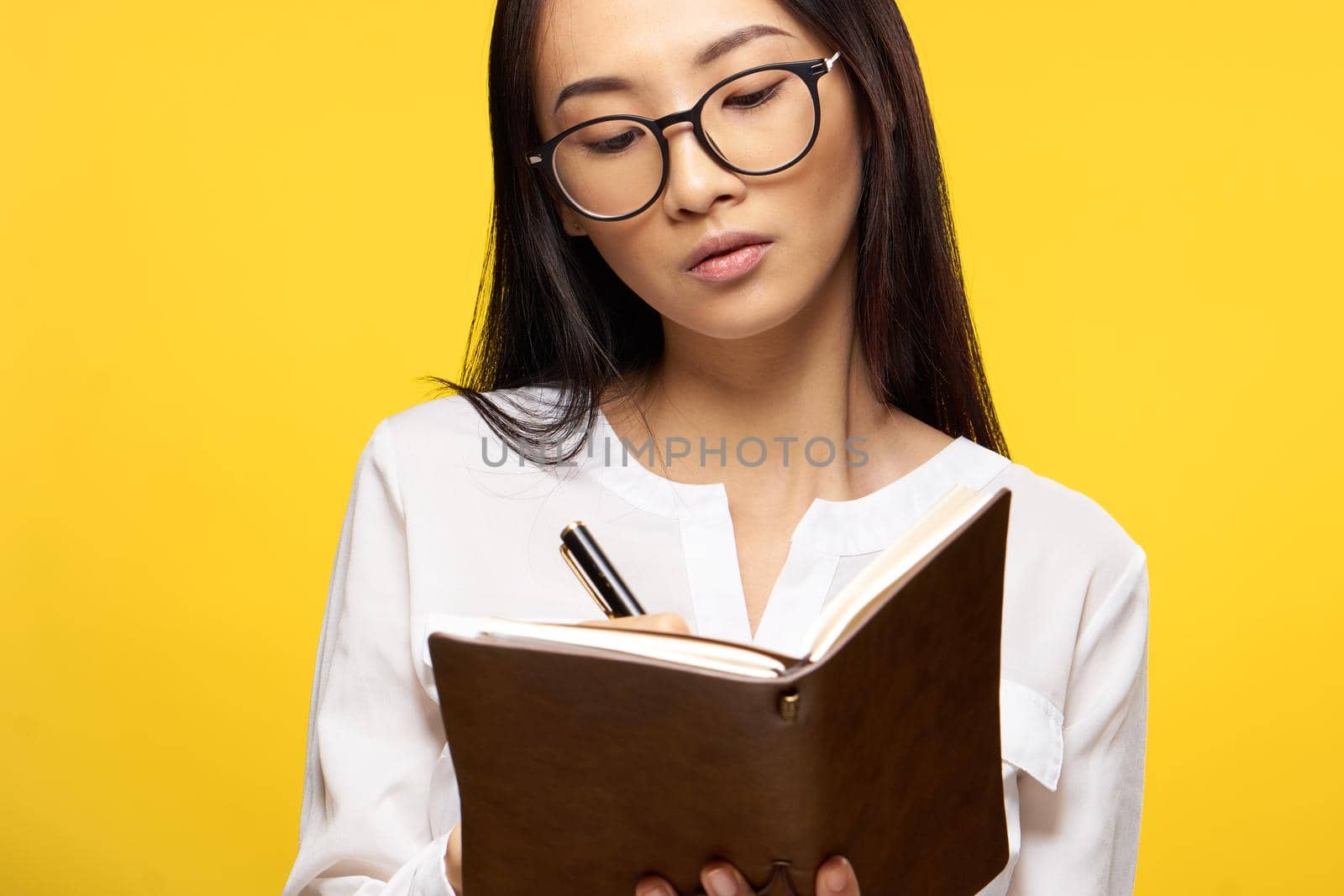 woman of asian appearance with notepad in hands executive office manager isolated background. High quality photo