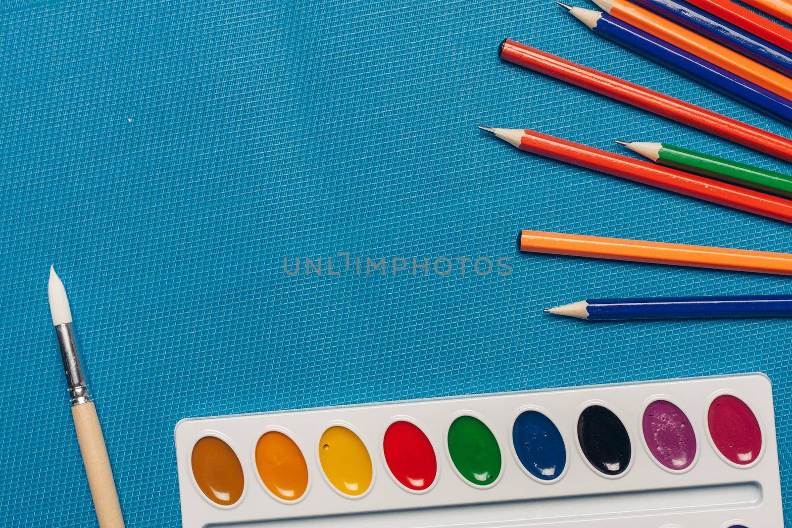 colored pencils watercolor paint art drawing art school blue background. High quality photo
