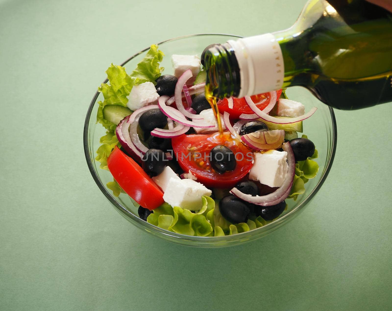 Greek fresh vegetable salad with feta cheese and olive oil in a bowl. Close-up, high-quality photo.