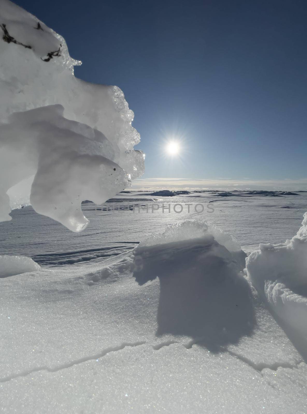 Ice slopes in sunny winter day, transparent ice of blue color, purely blue sky, long shadows, a pure snow-covered virgin soil, snow barkhans, by vladimirdrozdin