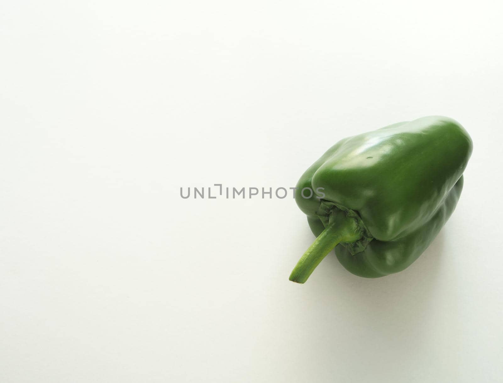 Ripe bell pepper, red, green, close-up on a white background.