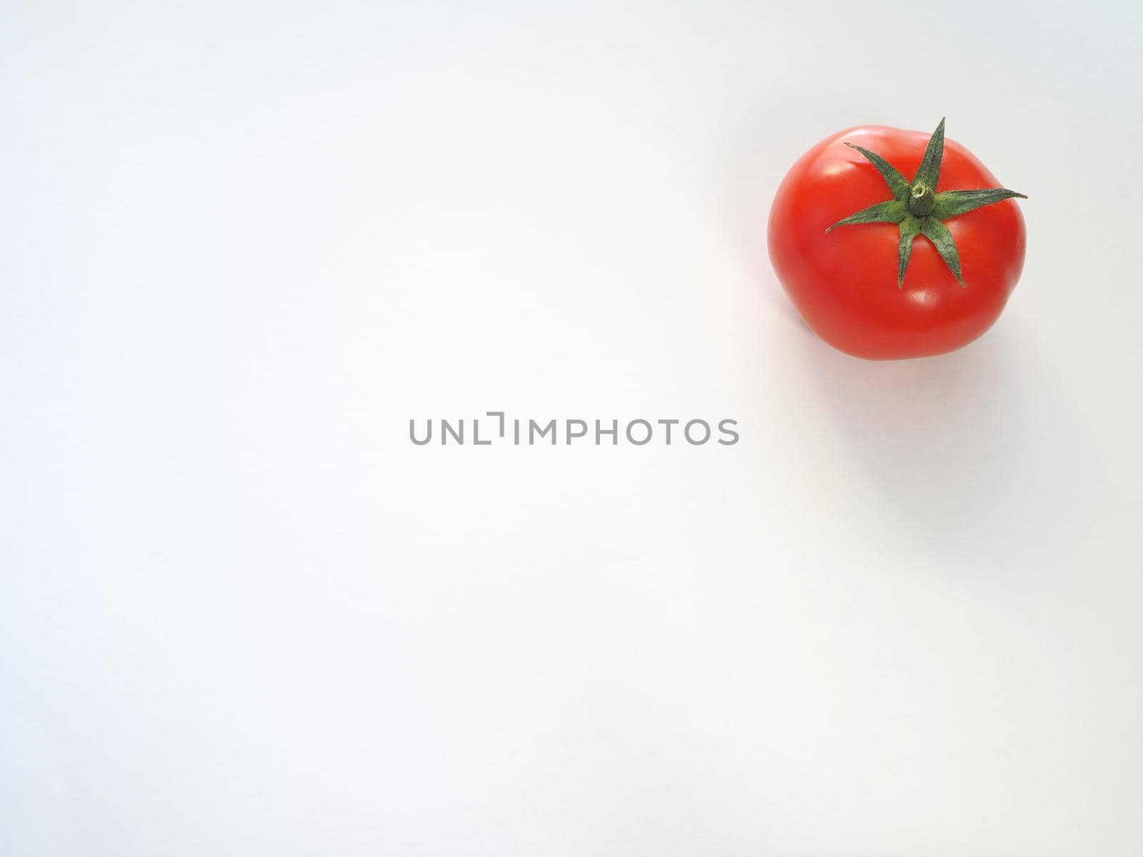 Red tomato on a white background. by Olga26