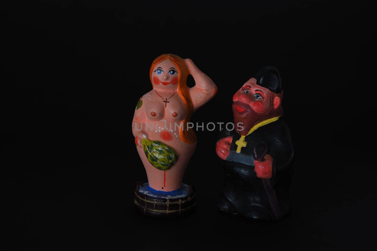 Funny figurines of plaster, clay and ceramics. Bath. The people in the steam room. It's a macro- Black background.