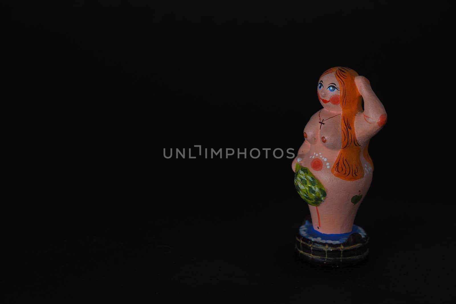 Funny figurines of plaster, clay and ceramics. Bath. The people in the steam room. It's a macro- Black background.