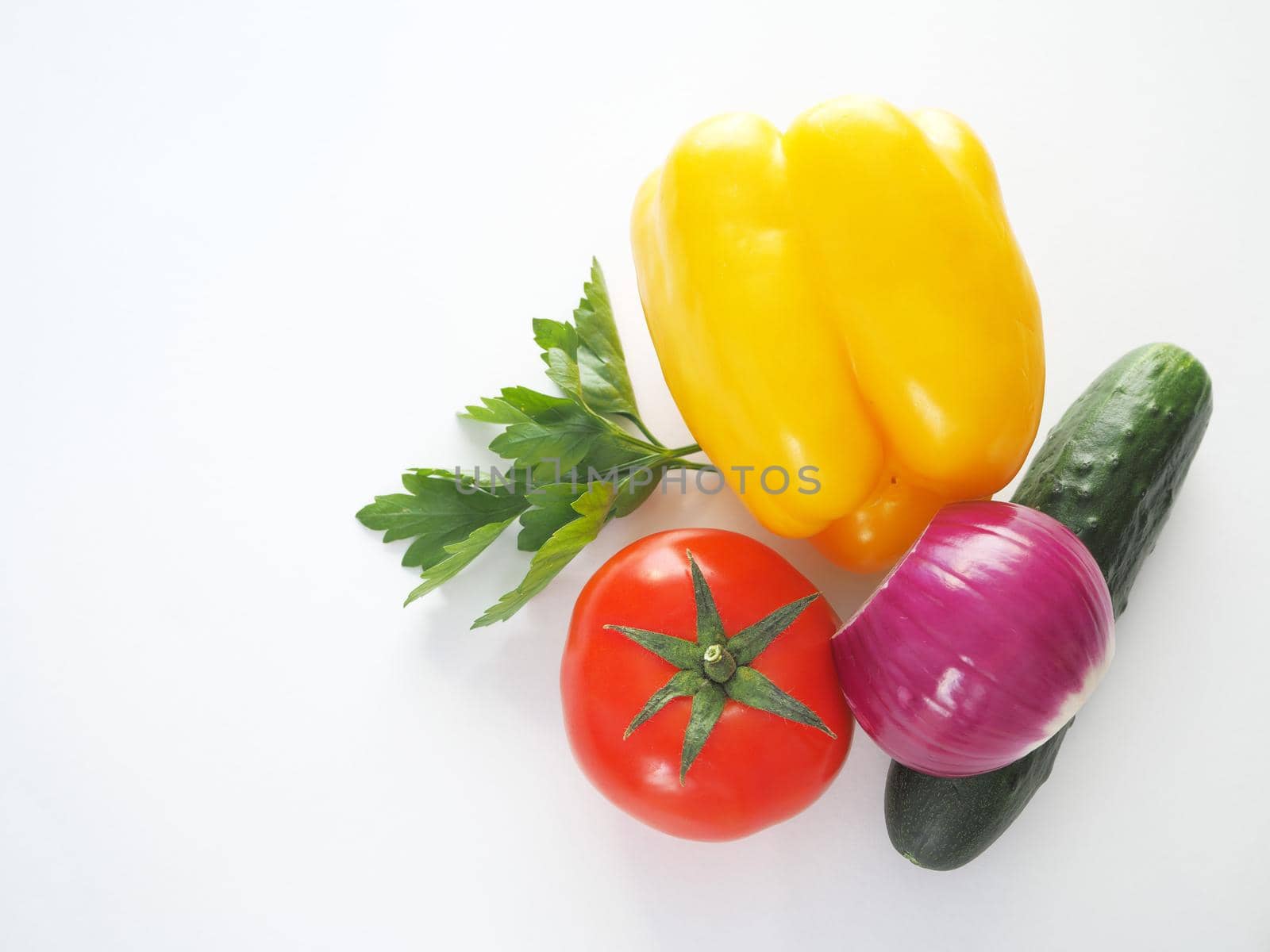 Fresh vegetables. Red tomato, bell pepper, and cucumber. Big plan on a white background.