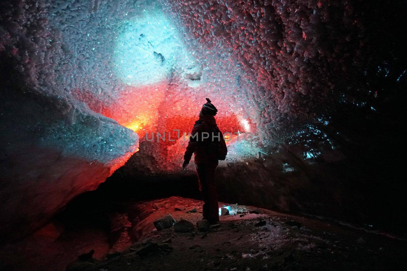 A guy in an ice cave with a lantern light. by Passcal