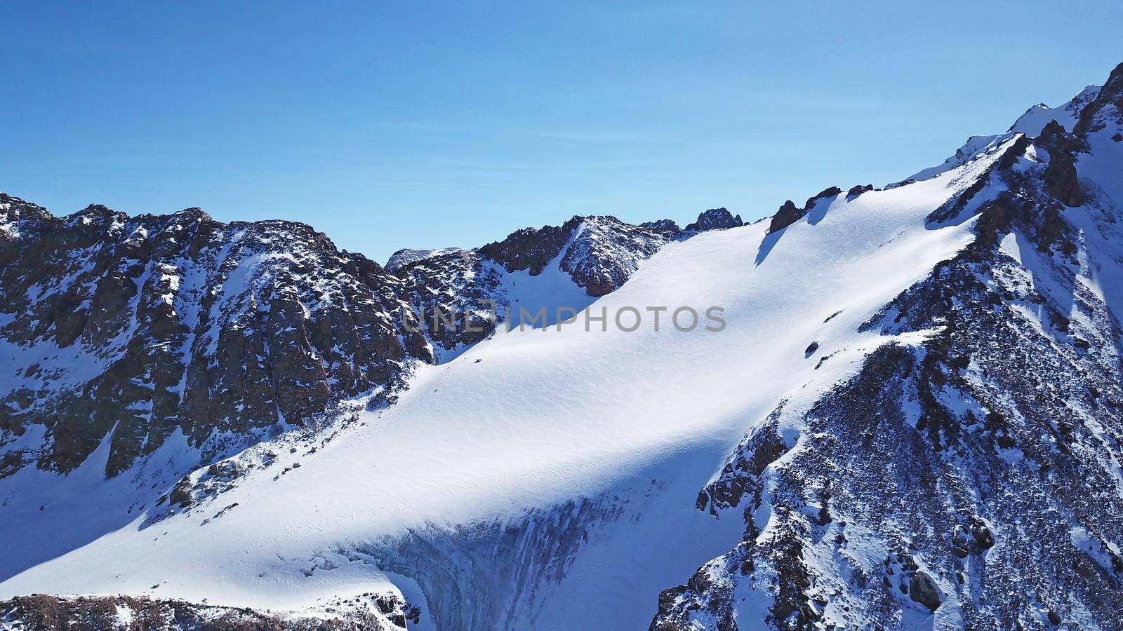 High snow-capped peaks and glaciers from the top. by Passcal