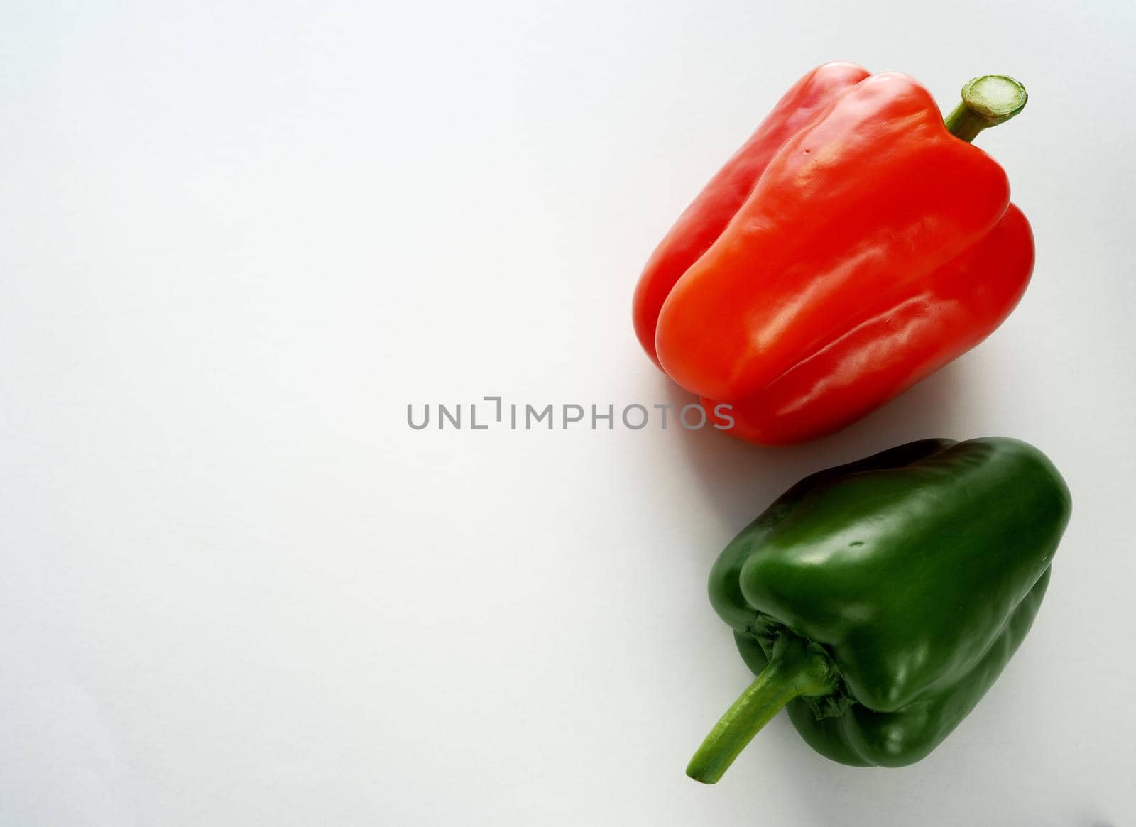 Ripe bell pepper, red, green, close-up on a white background.