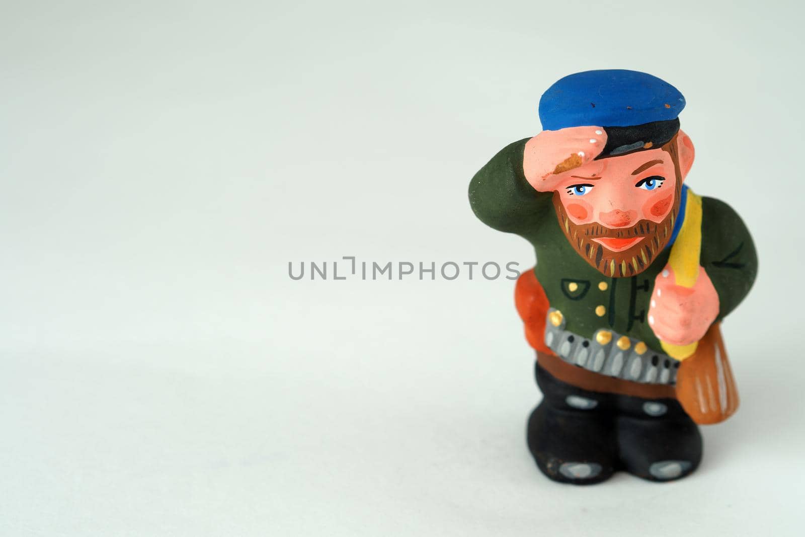 Funny figurines made of handmade ceramics. Man, hunter. Close-up.