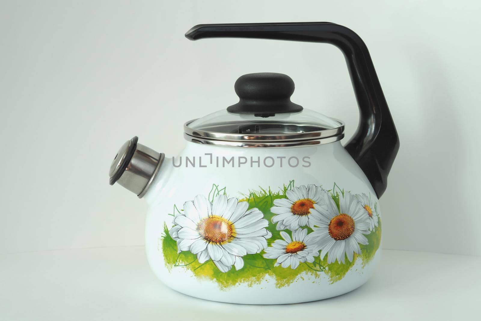 The kettle is enamelled white with a whistle and pattern. by Olga26