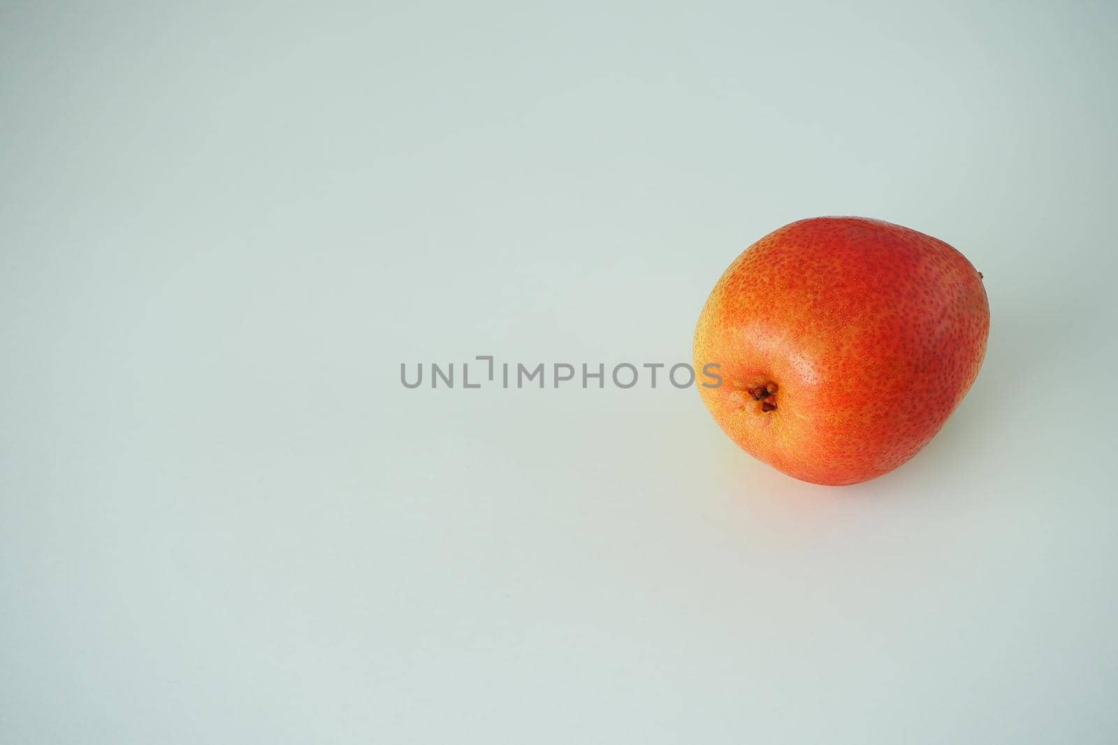 One ripe pear, close-up, on a white background. by Olga26