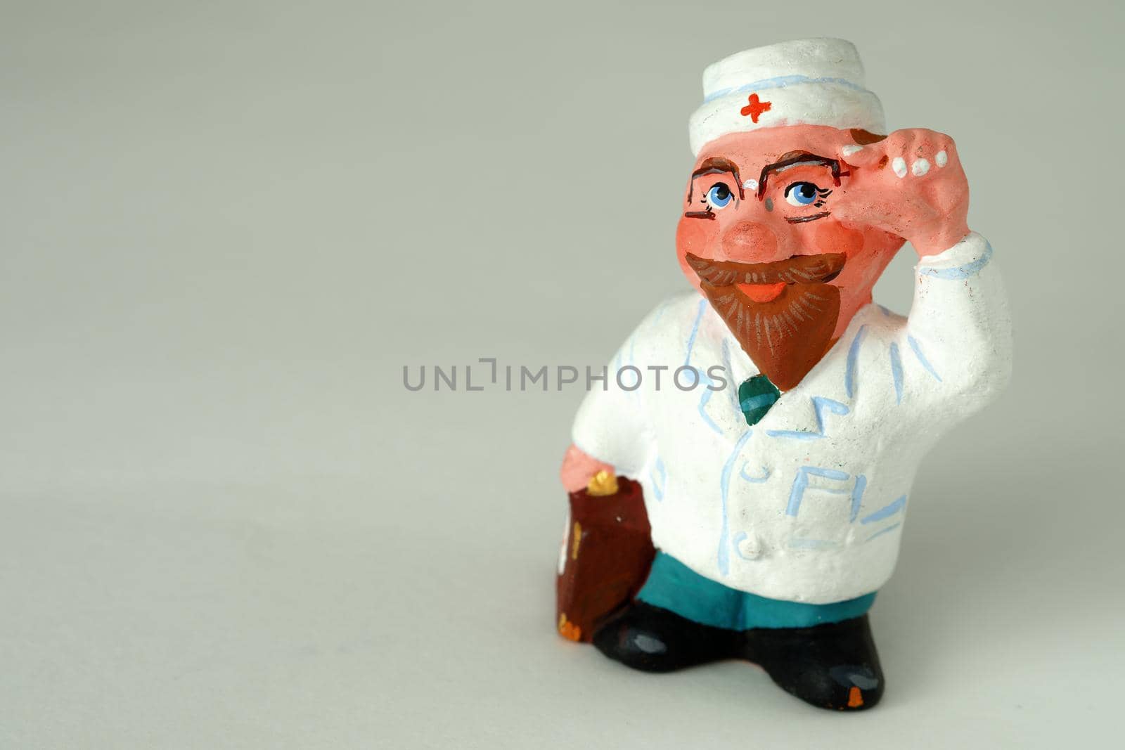 Funny handmade ceramic figurines. Souvenir. Doctor in a white coat.