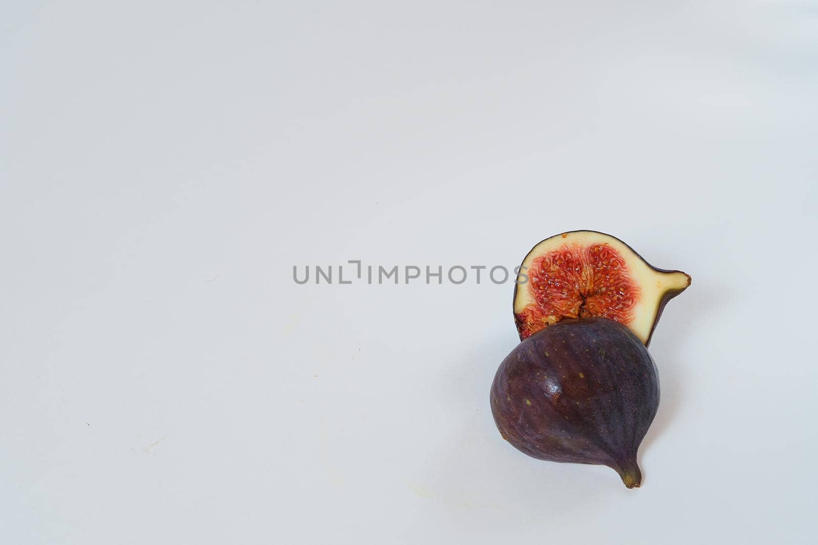 Food. Exotic fruit. Purple figs close up on a white background. by Olga26