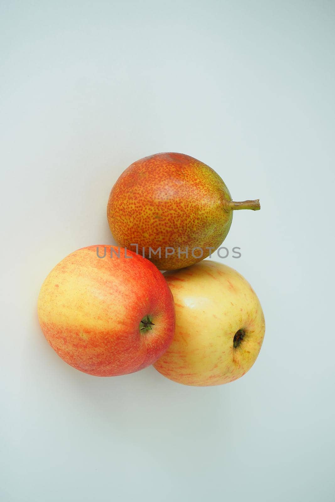 Ripe fruit. Pears and an apple on a white background. by Olga26