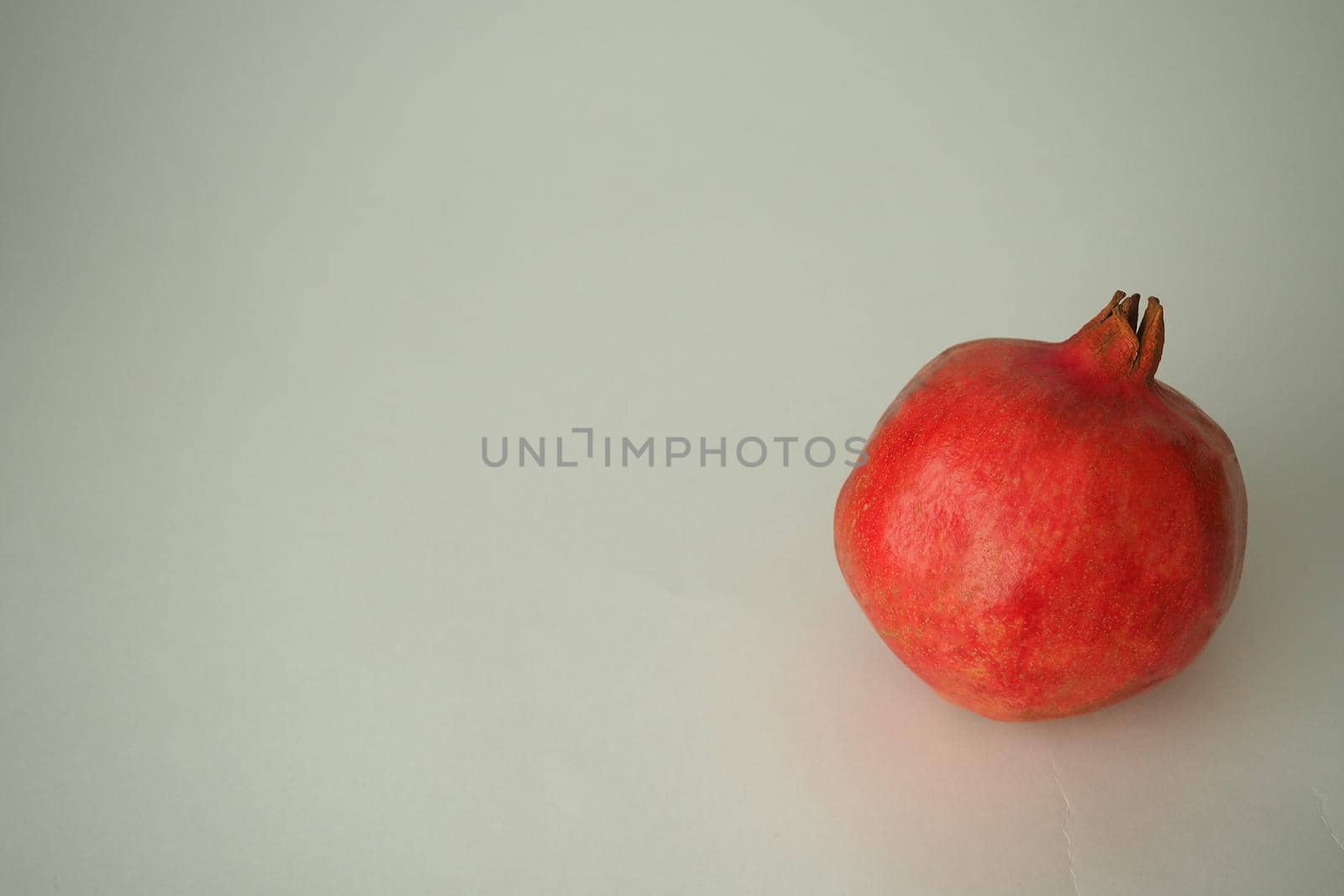 Pomegranate ripe, red round fruit. On a white background