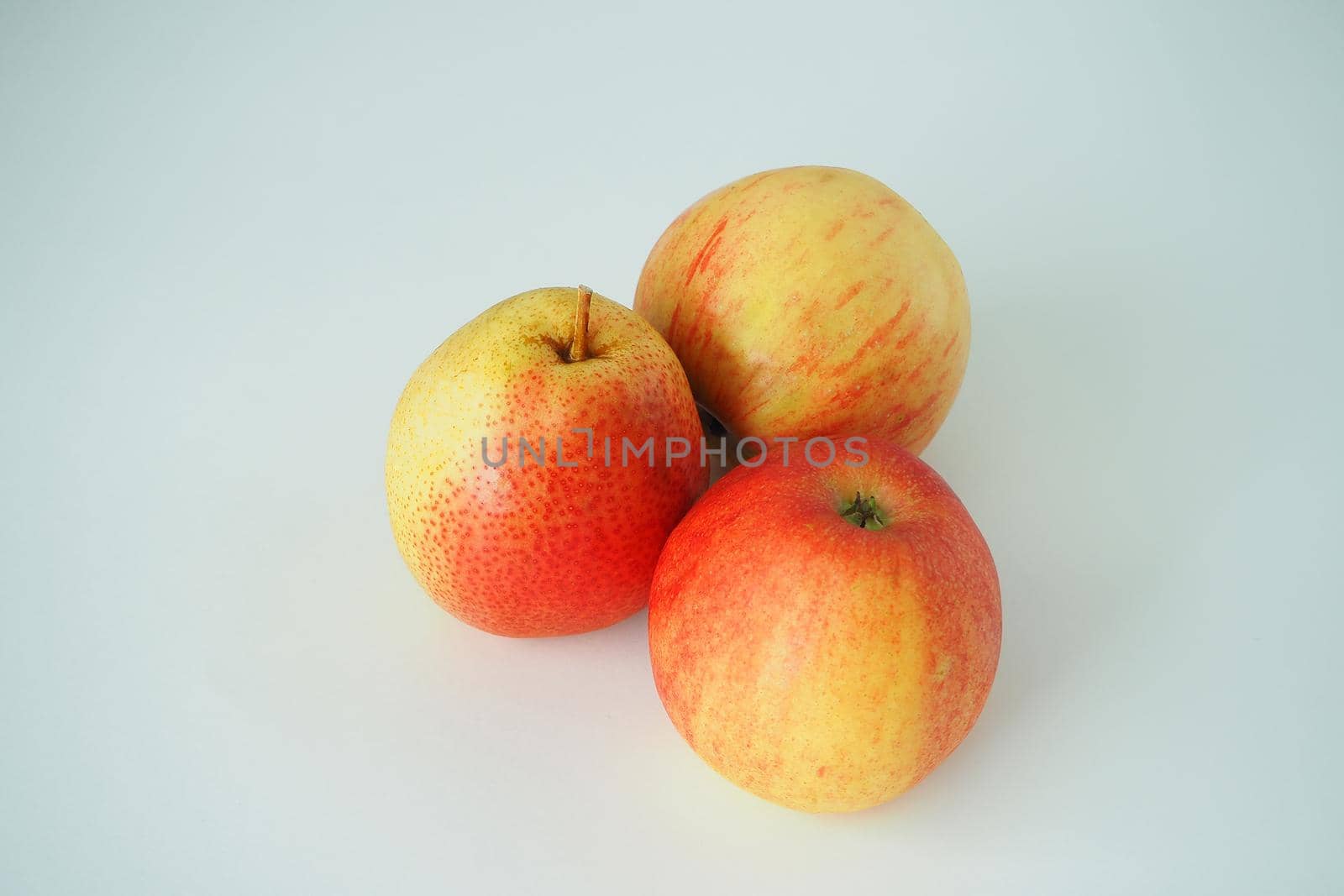 Ripe gouache and apples close-up on a white background. Close-up